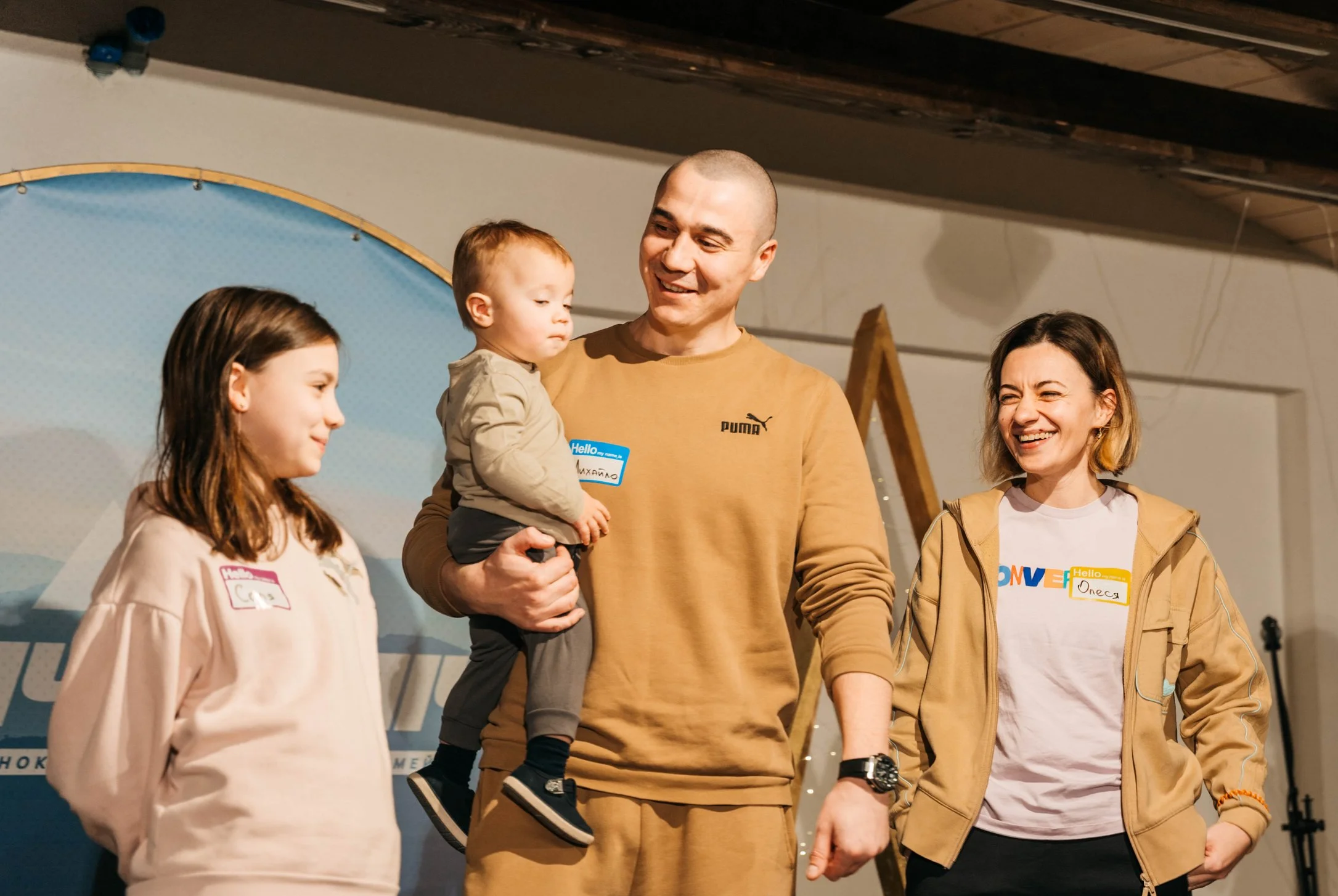 Ukrainian family participating in a UA Ants rehabilitation camp for veterans and their families, sharing their story at a US Ants–supported event.