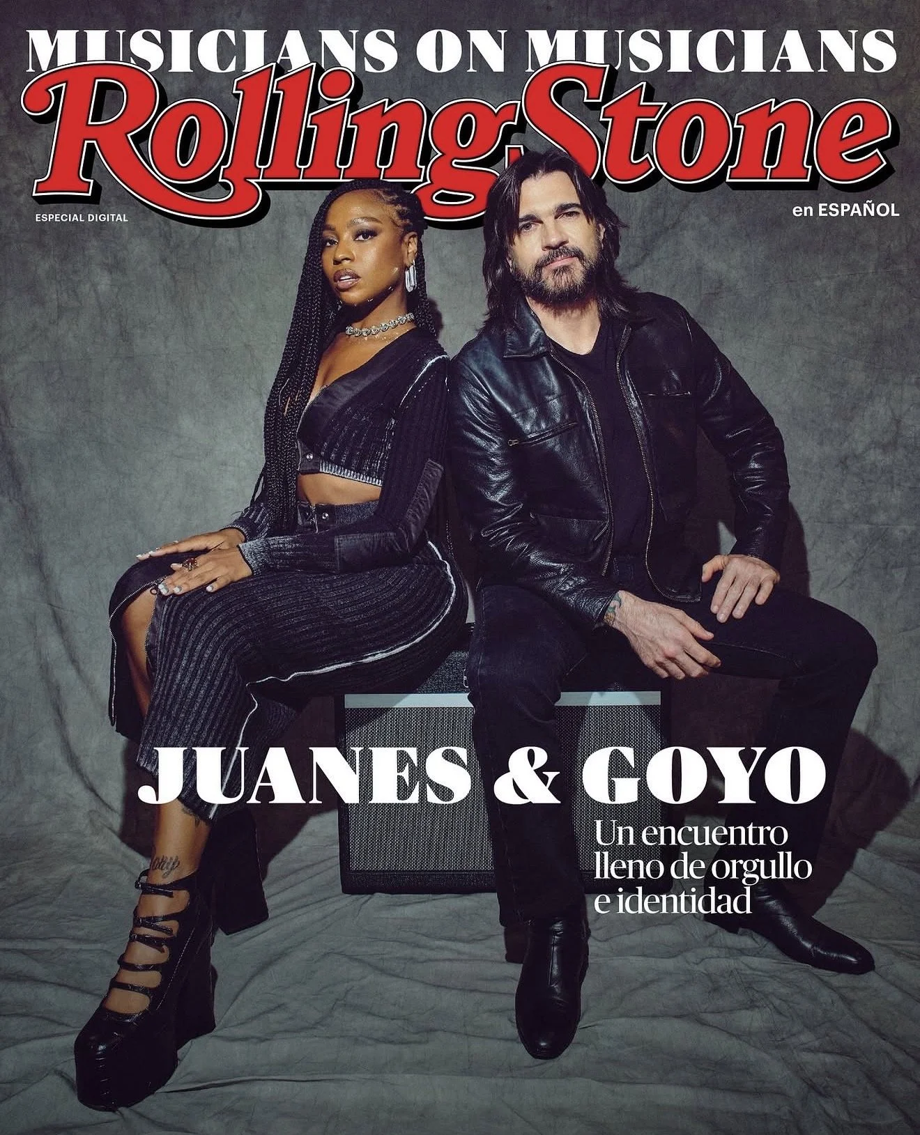 Magazine cover featuring two musicians, a woman with braided hair wearing a black and silver outfit and a man with long hair and beard wearing a black leather jacket, seated against a grey background. The magazine is titled "Rolling Stone" and has te