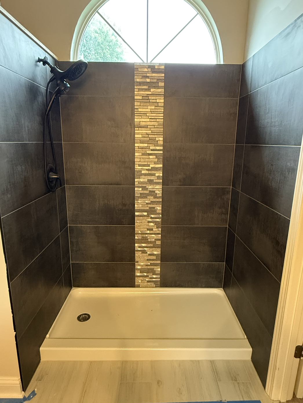 Hall bathroom renovation with varying tile and flooring
