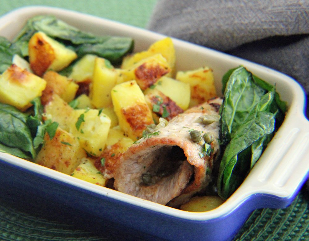 Tender veal piccata with capers and a lemon butter sauce, served with crispy golden potatoes and wilted spinach for a classic Italian-inspired meal.