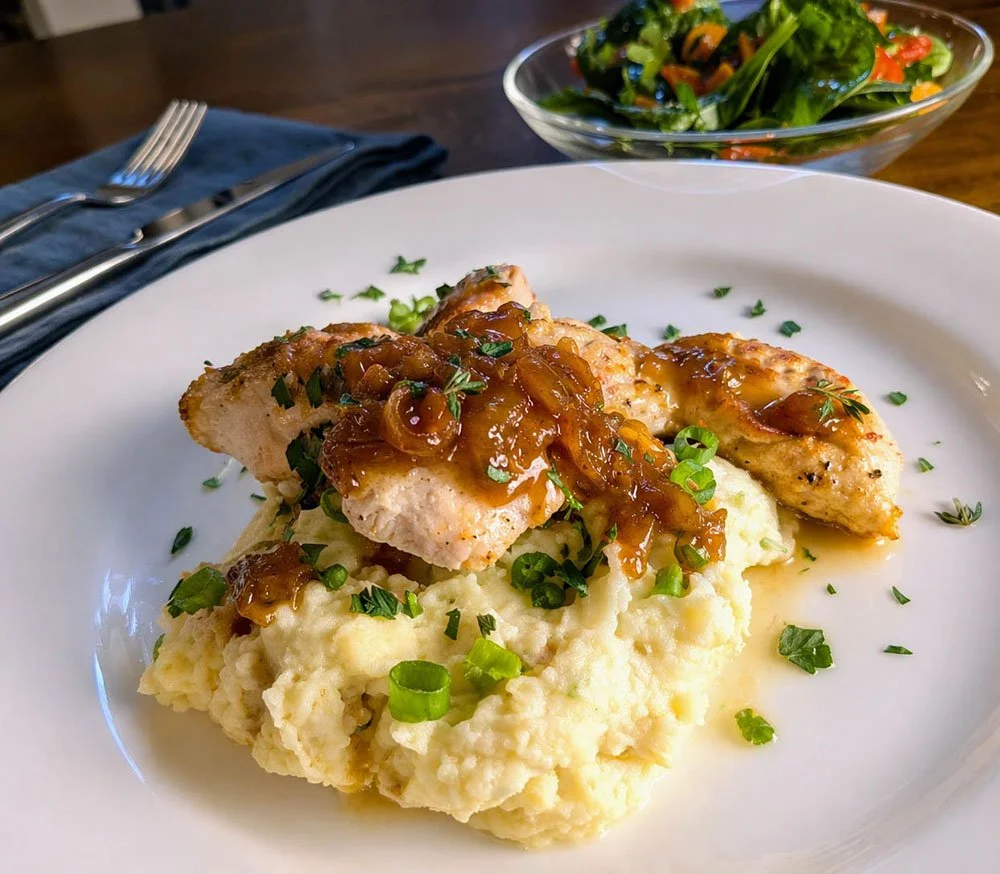 Orange chicken topped with caramelised onion sauce, served over creamy mashed potatoes with a spinach salad.