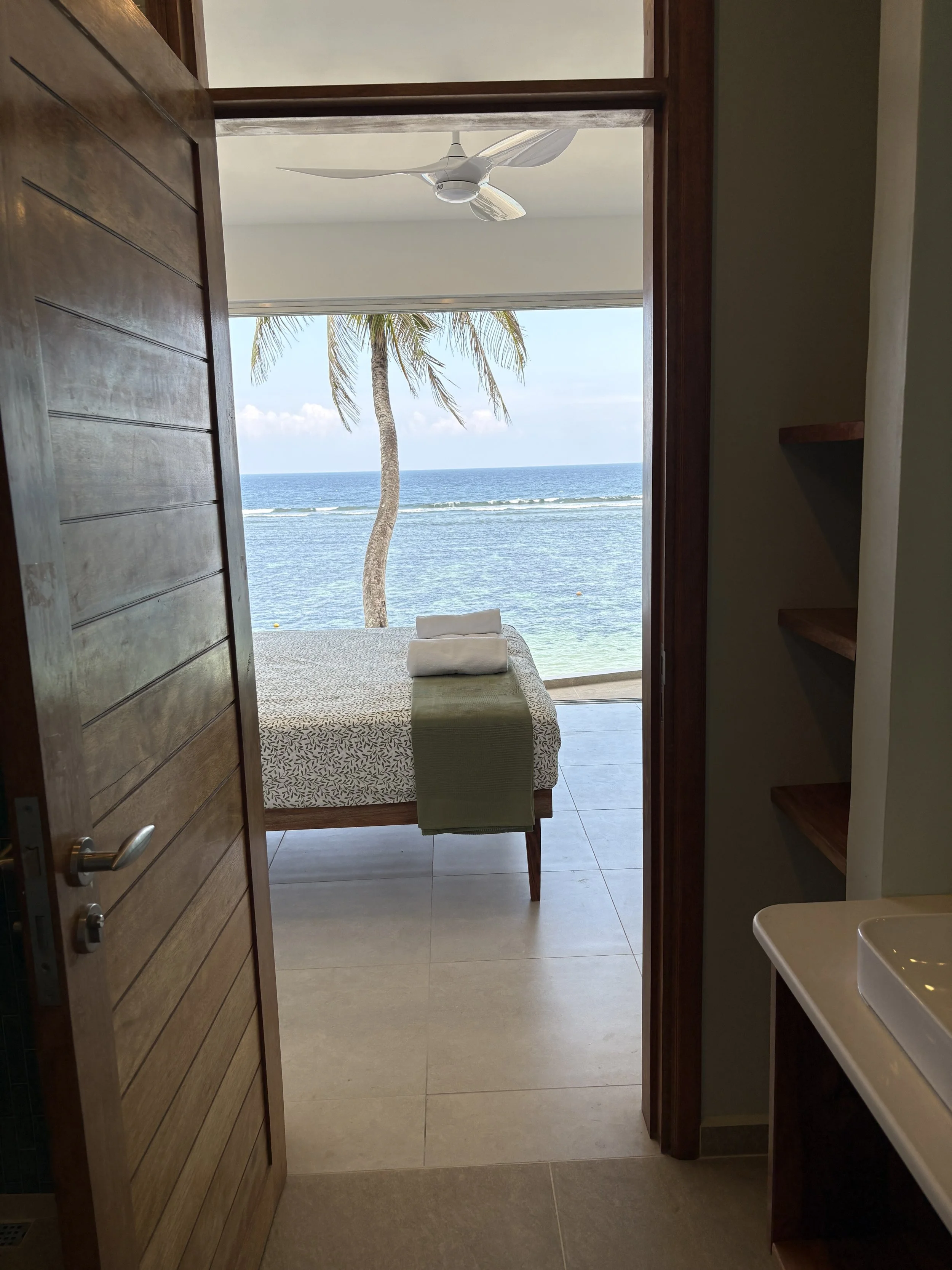 infinity view of indian ocean from master bathroom across bed.JPG