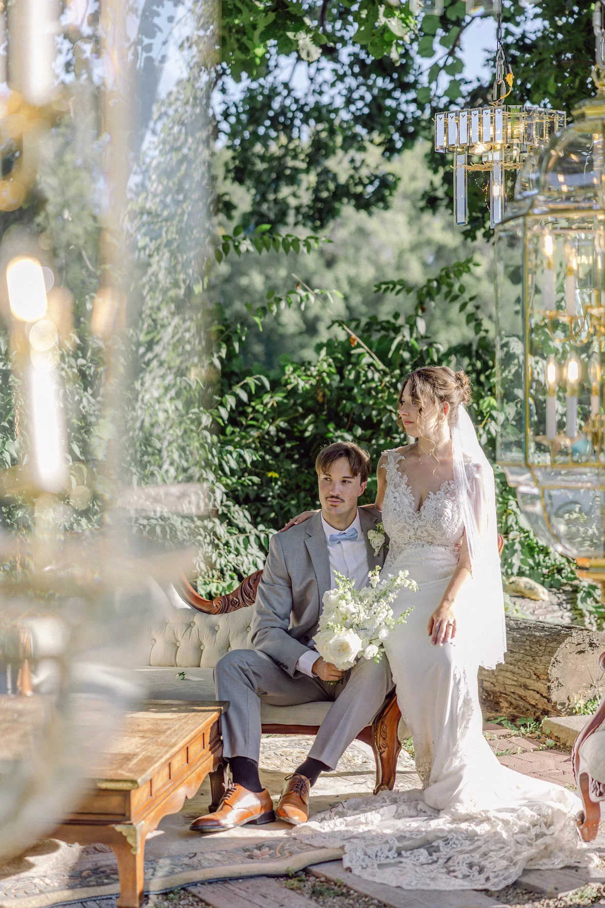 A man and woman couple at their wedding sitting on a couch