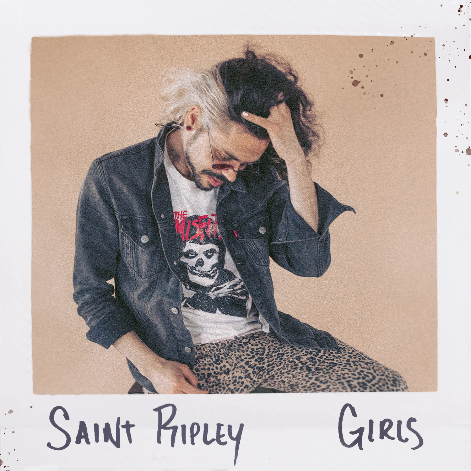 saint ripley album cover for girls - a man is running his hands through his long black hair which is bleached blond on the side.  it is framed as if it is an instant polaroid photo with handwriting on the bottom.