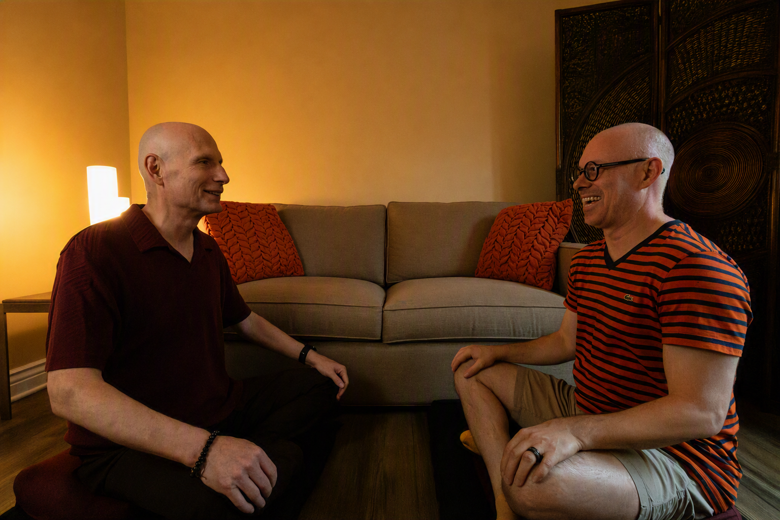 Image of two people on cushions conversing face-to-face.