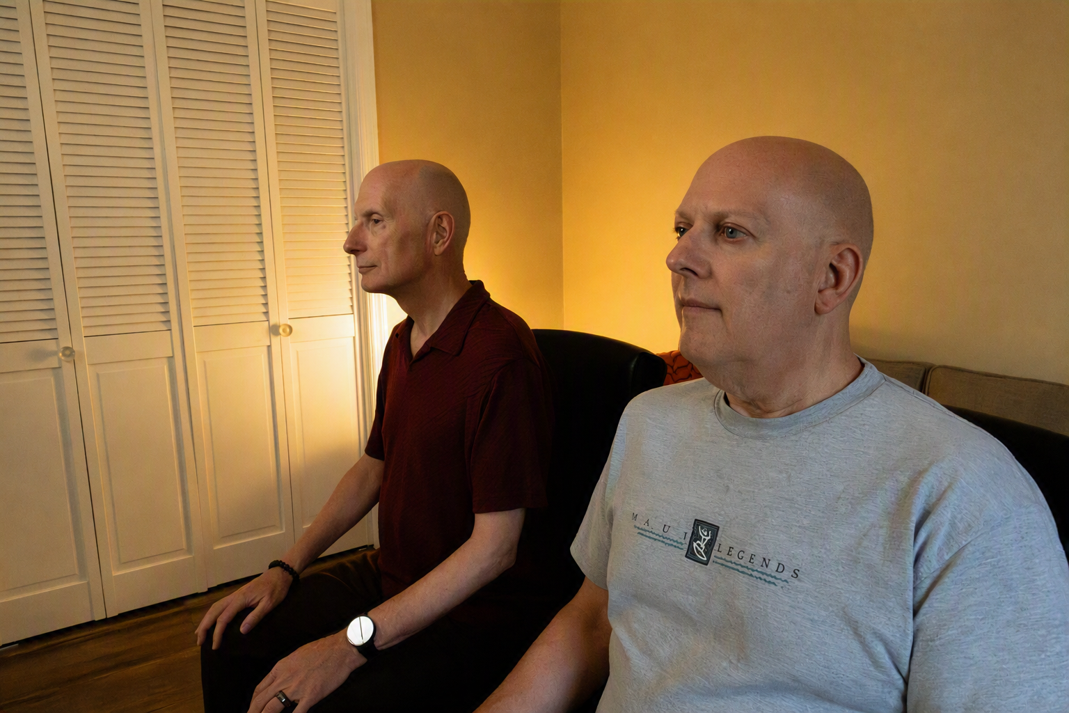 Image of two people in seated meditation on cushions.