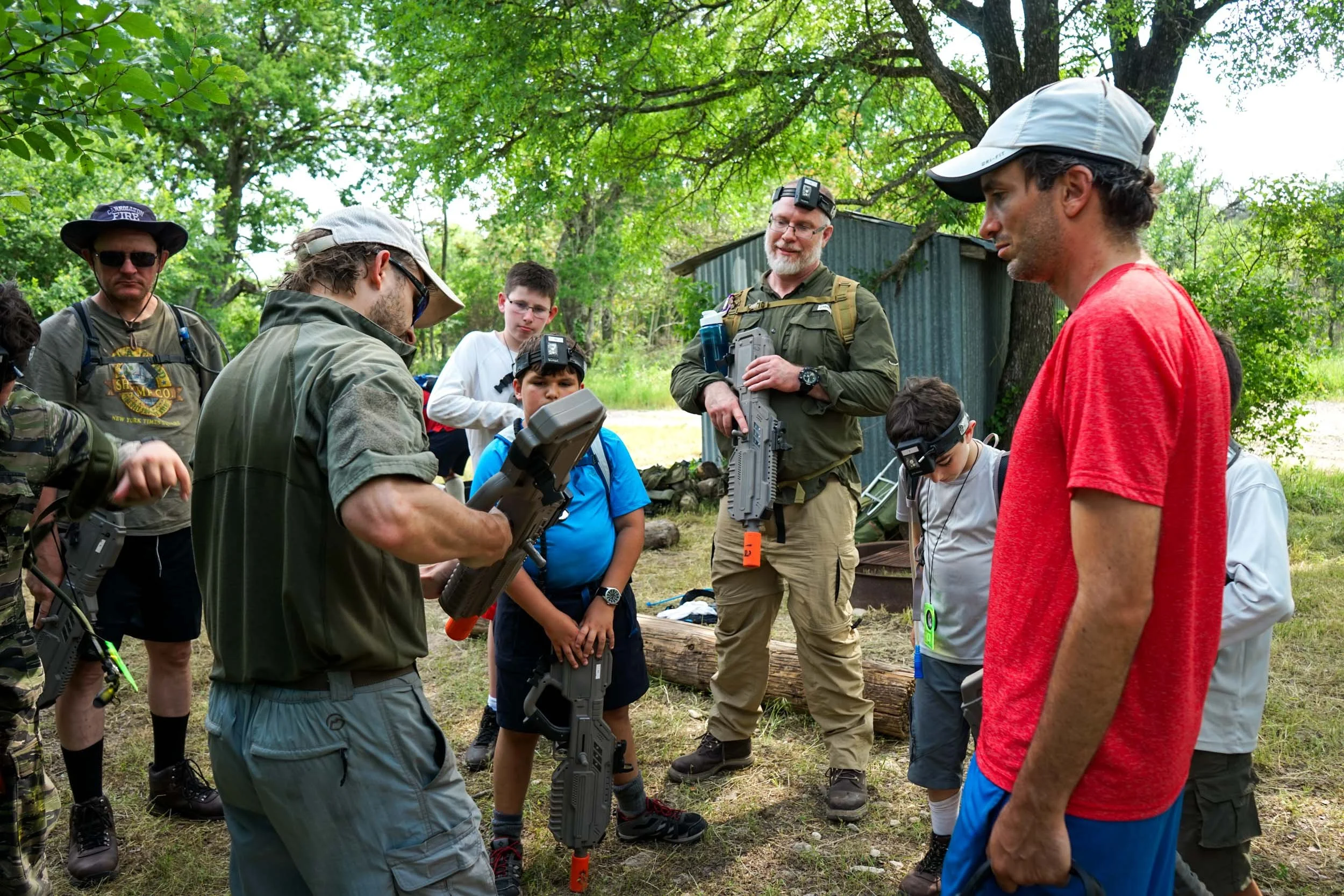 Group of dads and sons preparing for a laser tag mission.