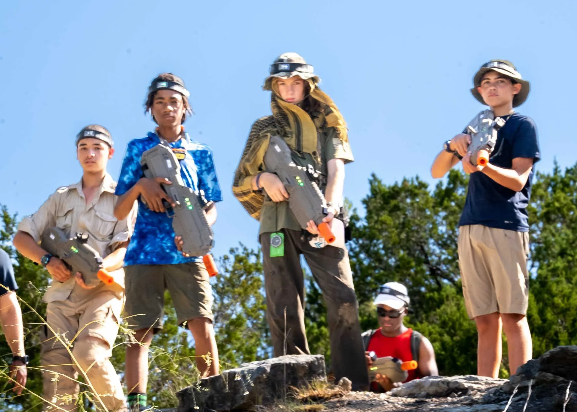 Group of campers holding laser tag guns.