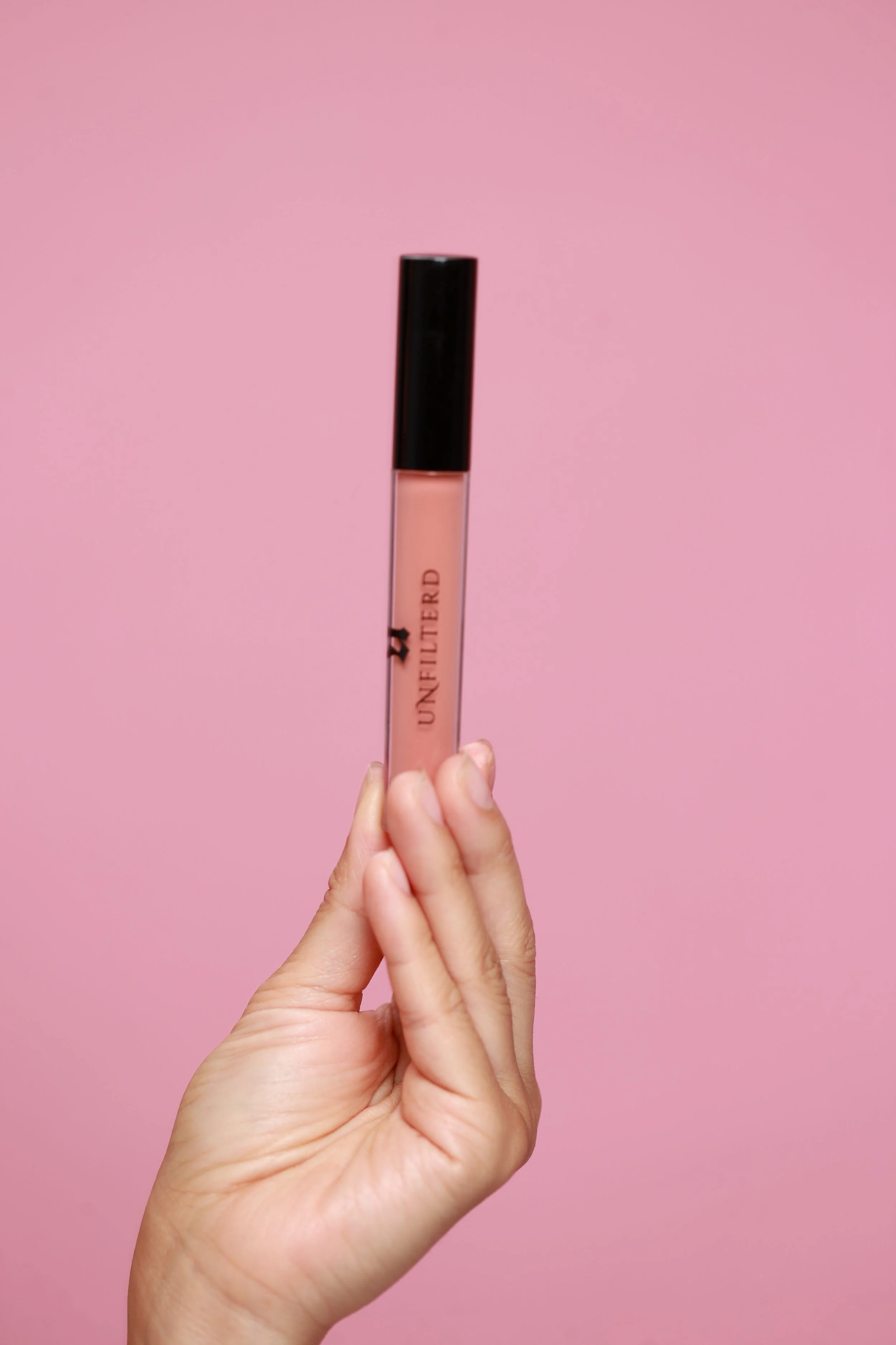 hand holding Dream lip gloss