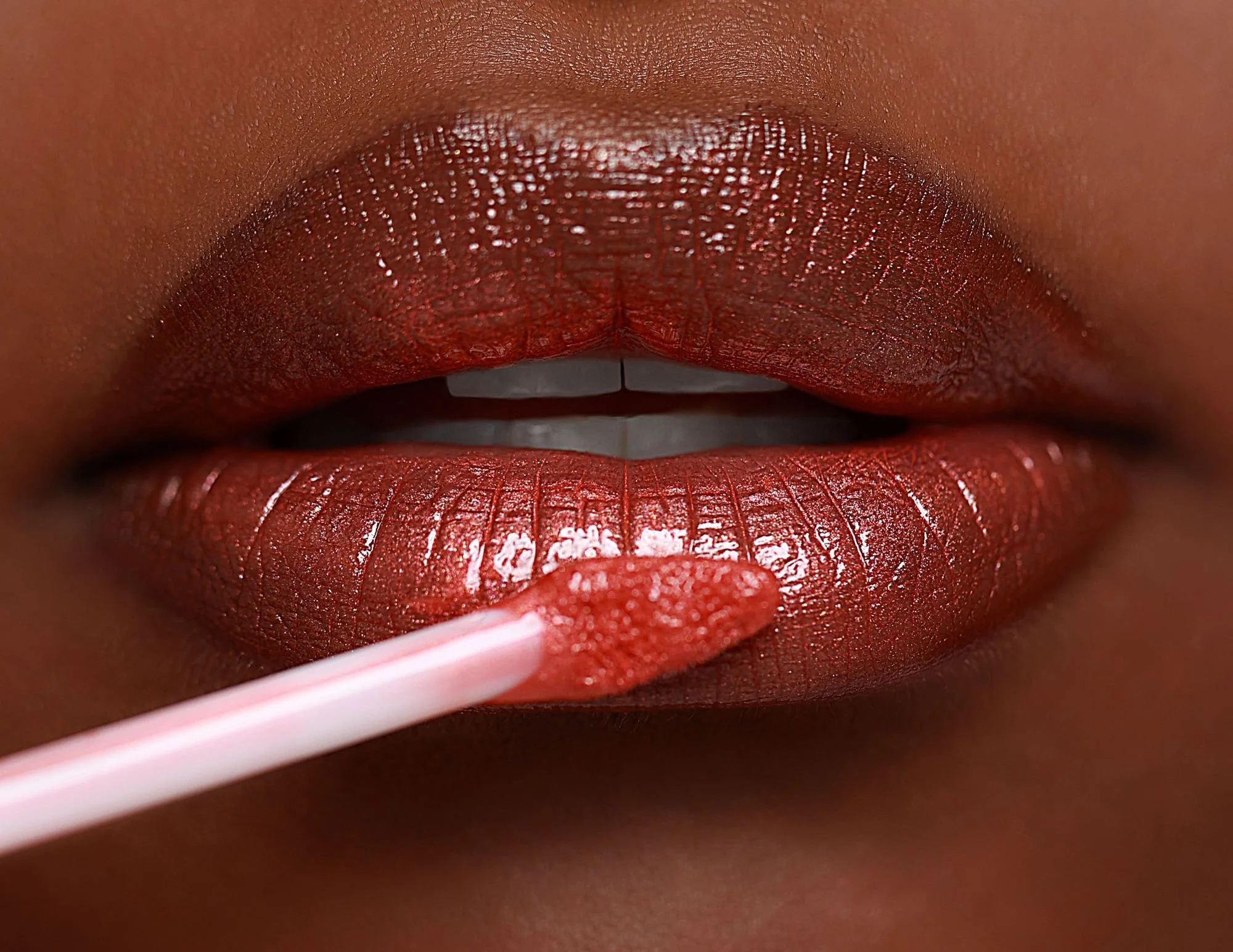 Tropical Tease lip gloss being applied to lips.