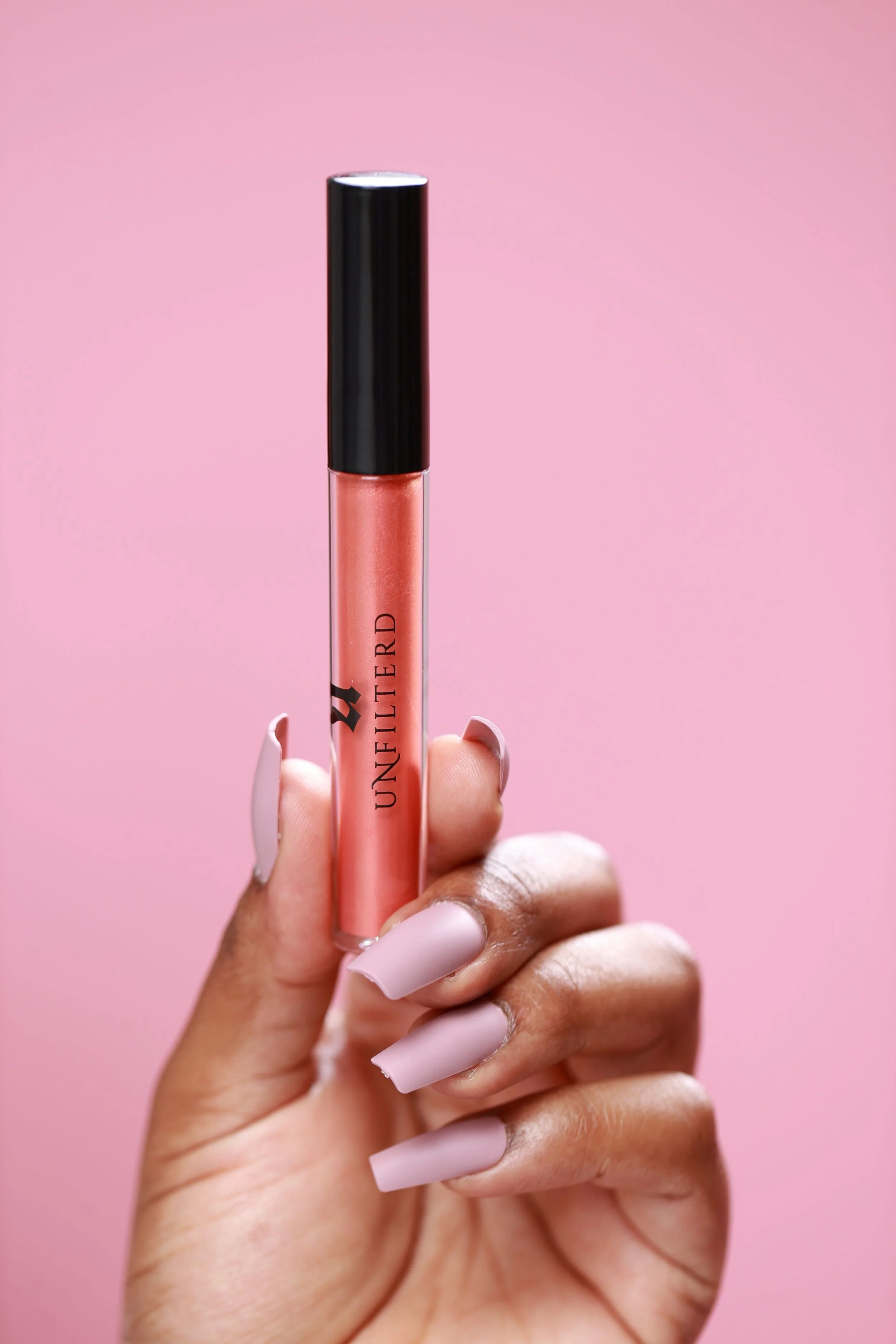 Hand holding Tropical Tease Lip Gloss