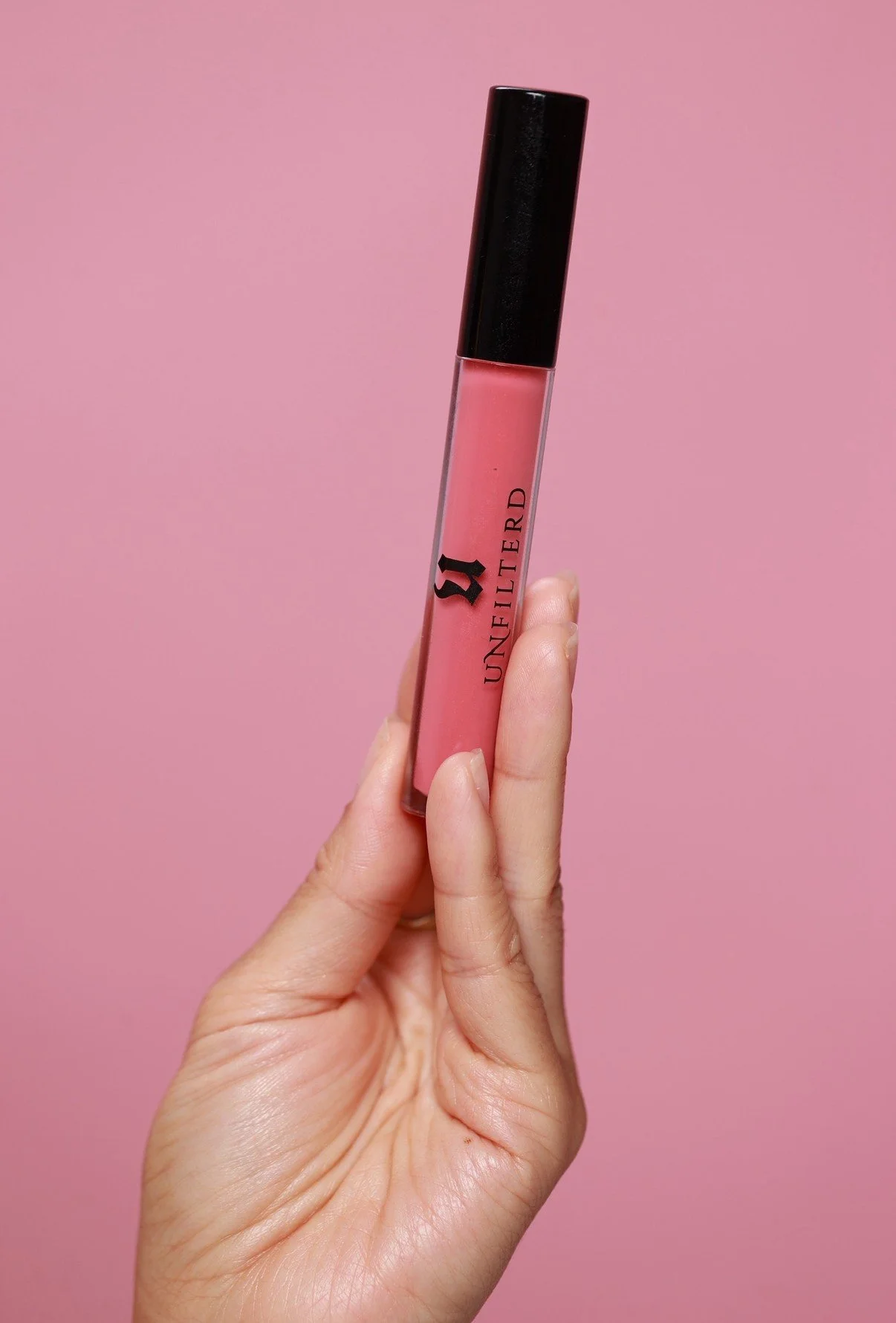 hand holding tube of Luxe lipgloss