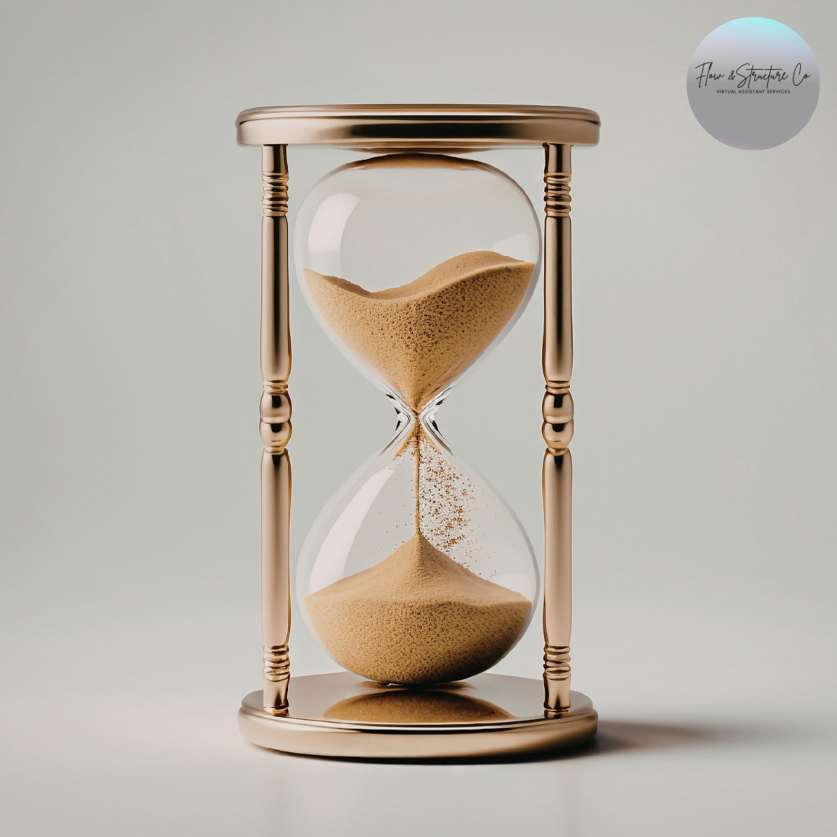 An hourglass with flowing sand, positioned on a reflective surface, with a logo in the top right corner reading 'Flow & Structure Co Virtual Assistant Services'.