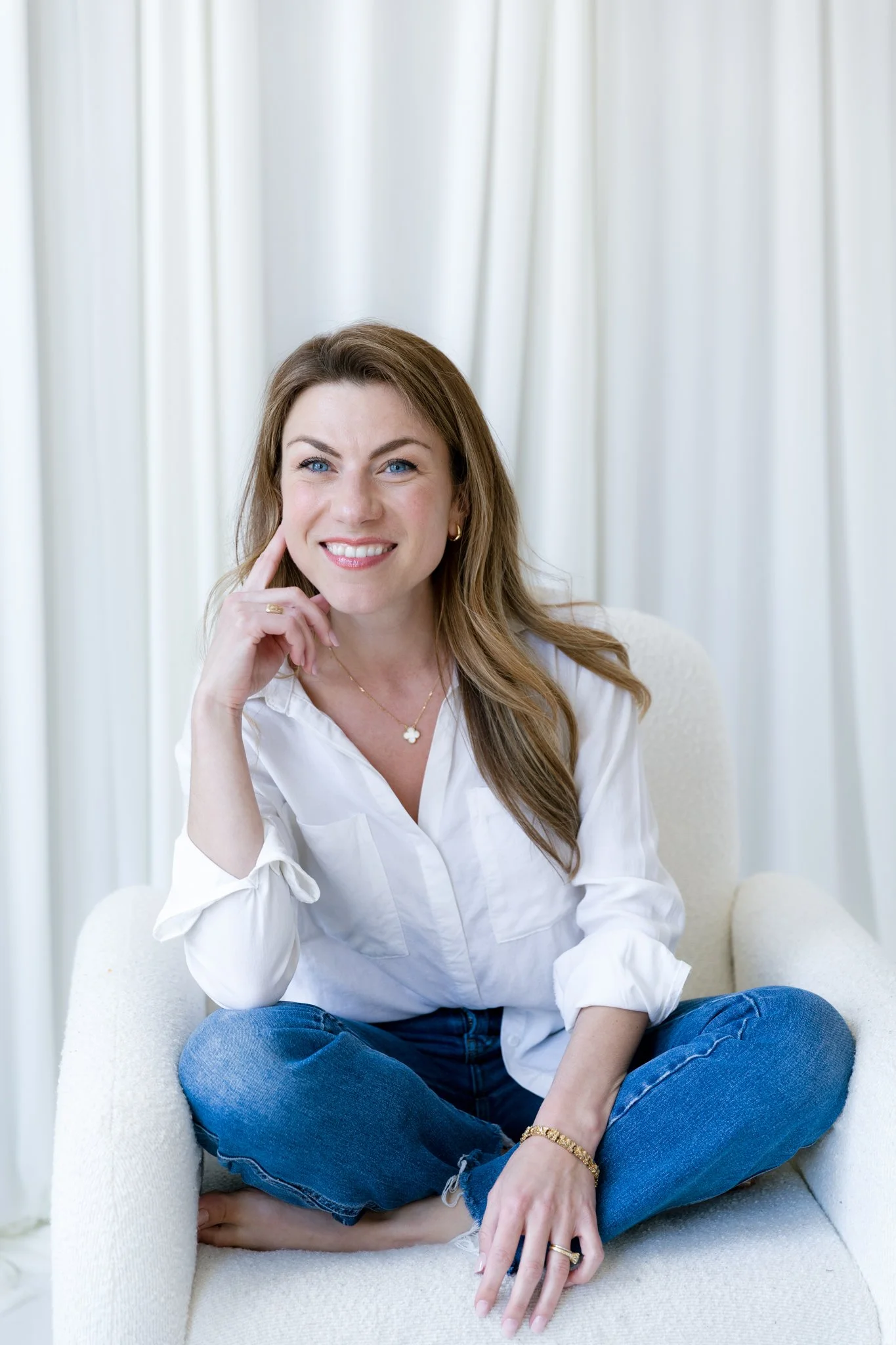 Alex Merola sitting in an armchair, smiling warmly.