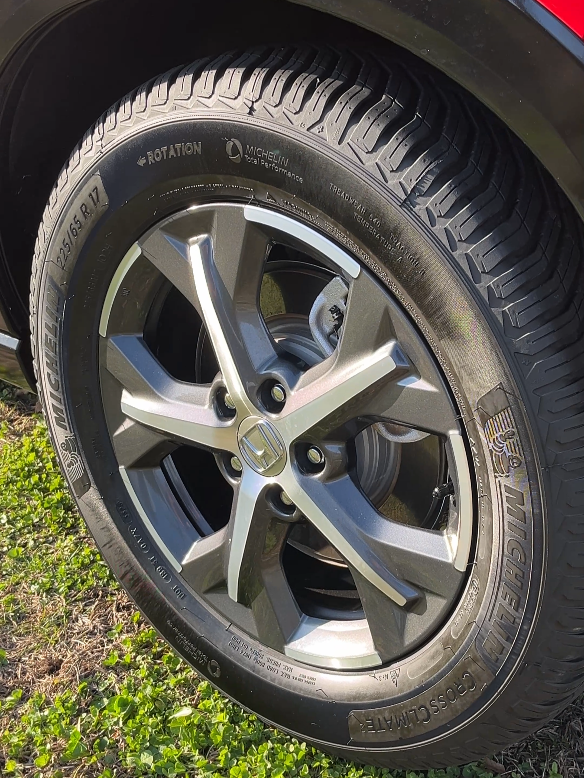 Close-up of a car wheel with a Honda logo on the rim, mounted with a Michelin tire.