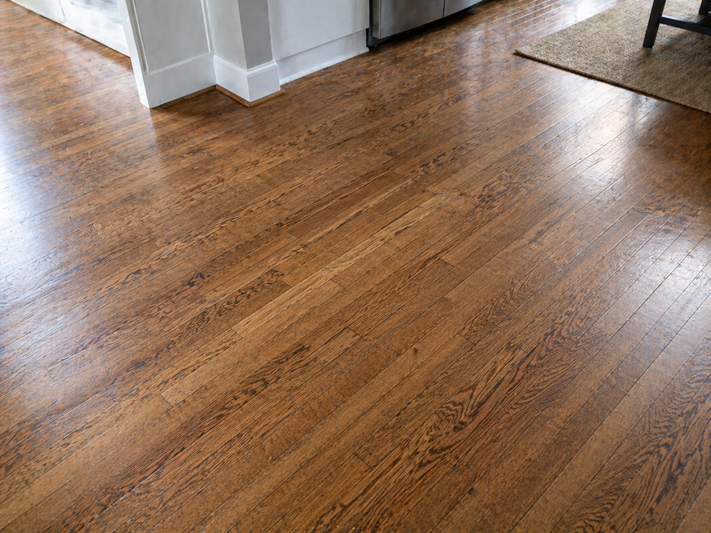Seamless hardwood floor repair blending new oak boards into an existing Kansas City hardwood floor