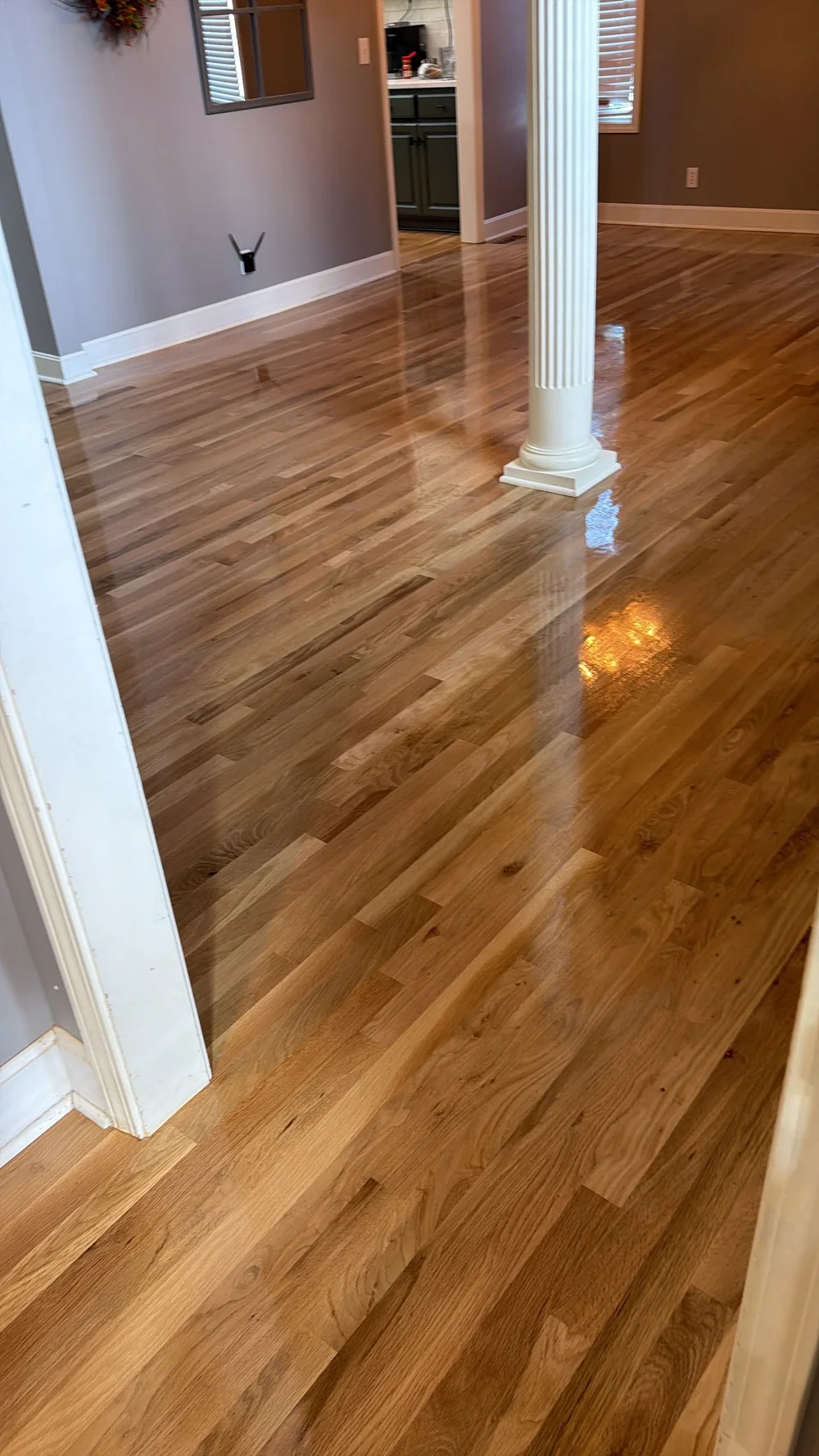 New hardwood continuing through a room and doorway in an Olathe home