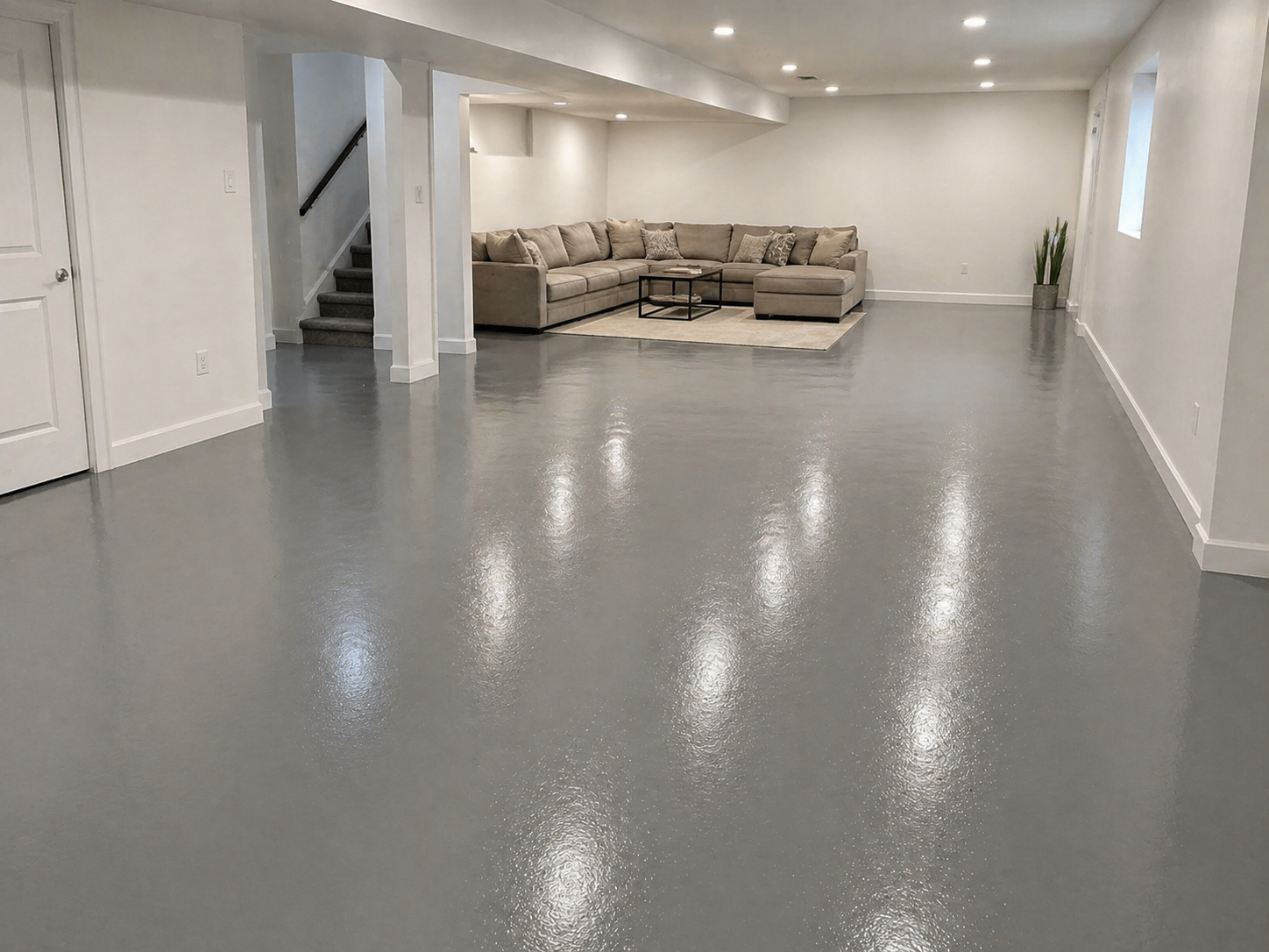 Solid gray polyaspartic concrete coating on a finished basement floor in a Kansas City home