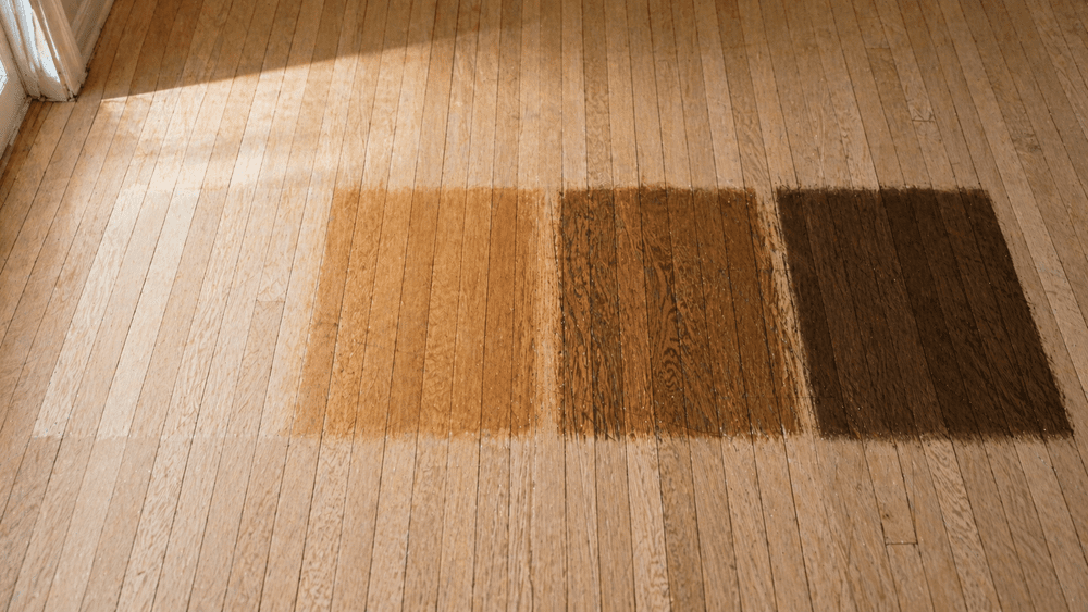 Hardwood floor with stain test areas for comparing color