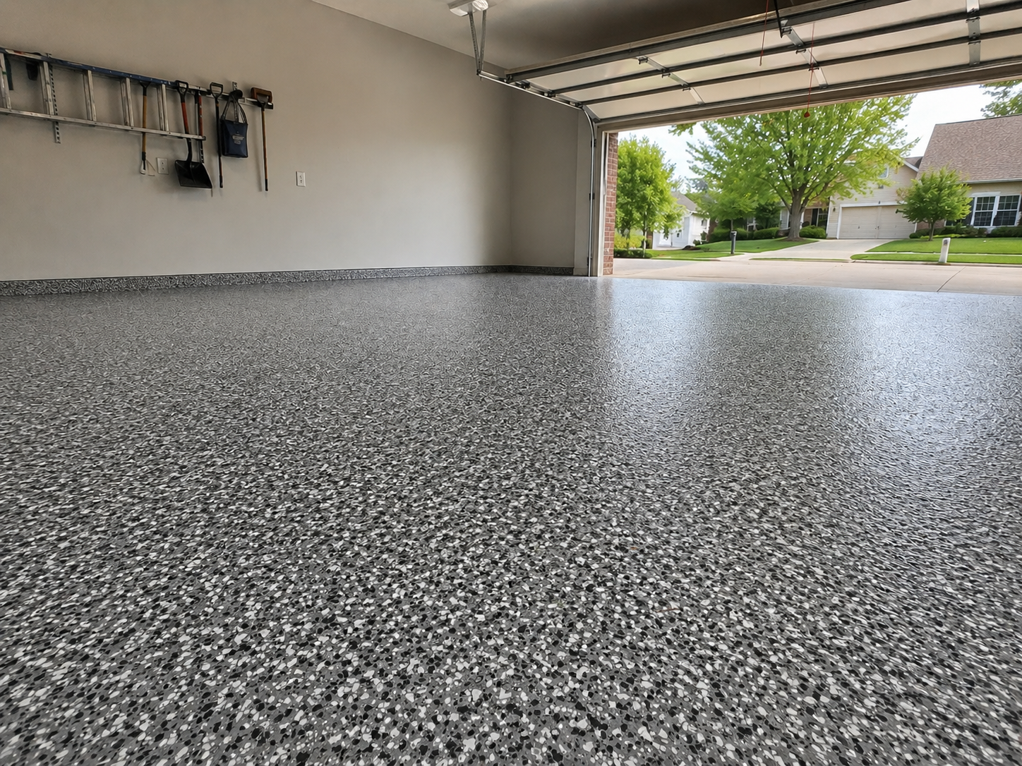 Gray flake polyurea garage floor coating in a Kansas City residential garage