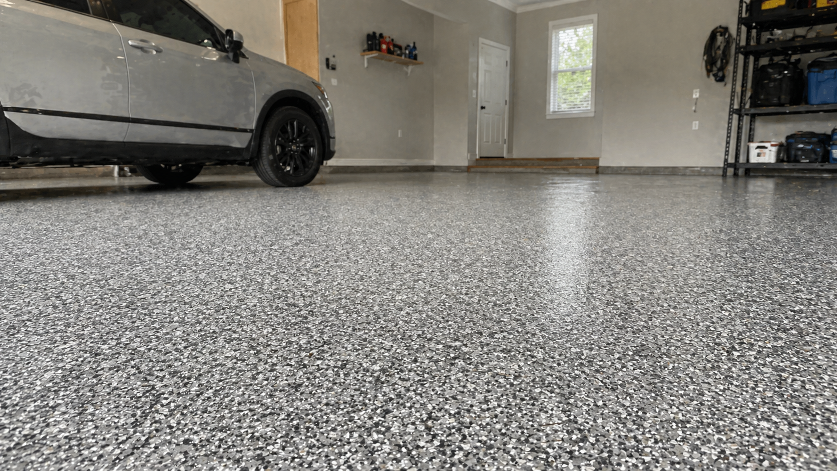 Polyurea garage floor coating with gray flake finish in Kansas City garage
