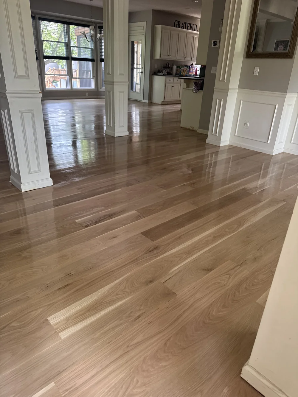 Refinished hardwood through connected rooms in a Leawood home
