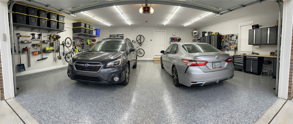 Gray decorative chip garage floor beneath two parked vehicles
