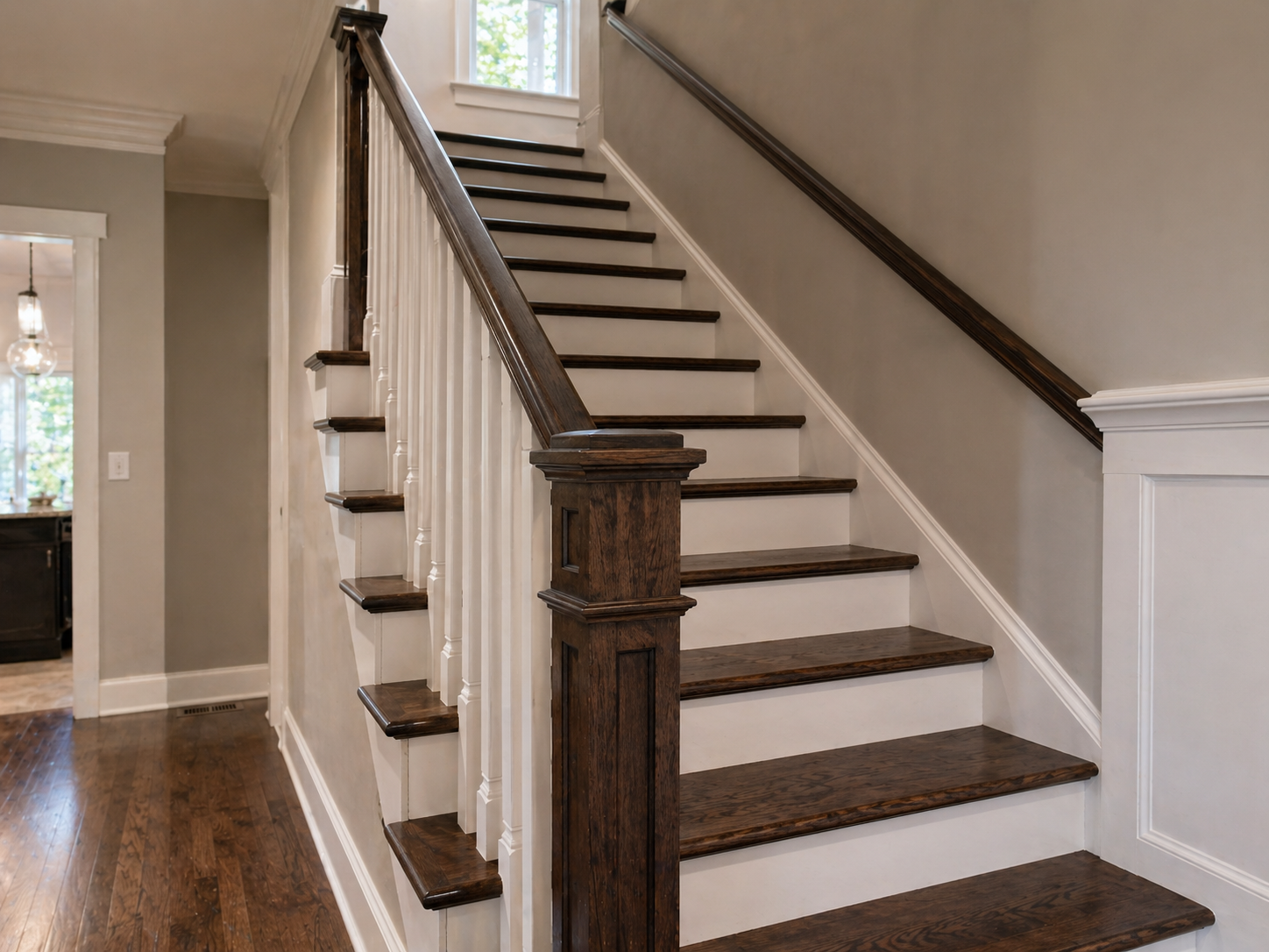 Refinished hardwood stairs with espresso treads and white risers in a Kansas City home