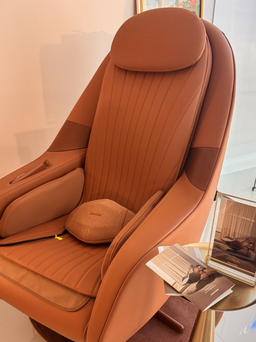 A cushioned Ceragem massage chair in warm tan leather