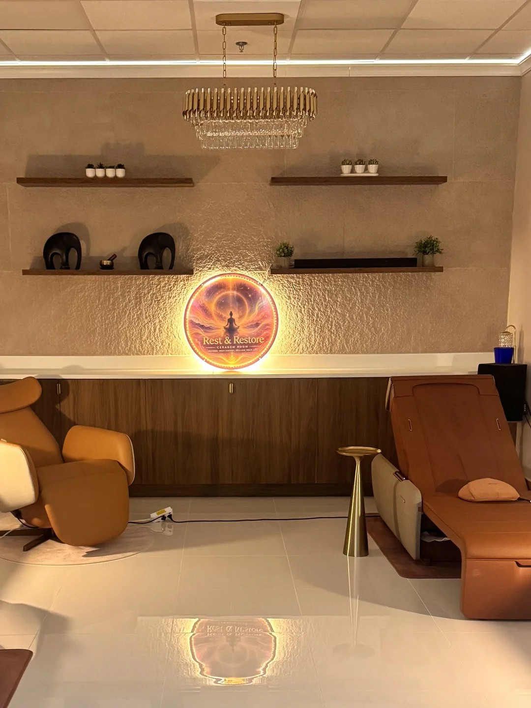 The studio's relaxation lounge with a glowing wall medallion and reclining chairs