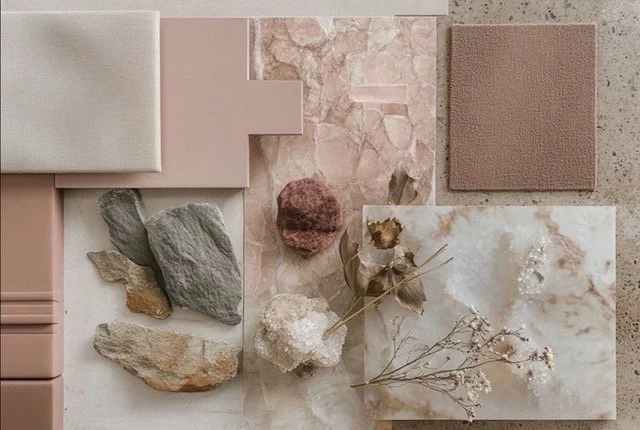 A flat lay of various pink, beige, and gray decorative materials including tiles, stones, fabric, and dried flowers.