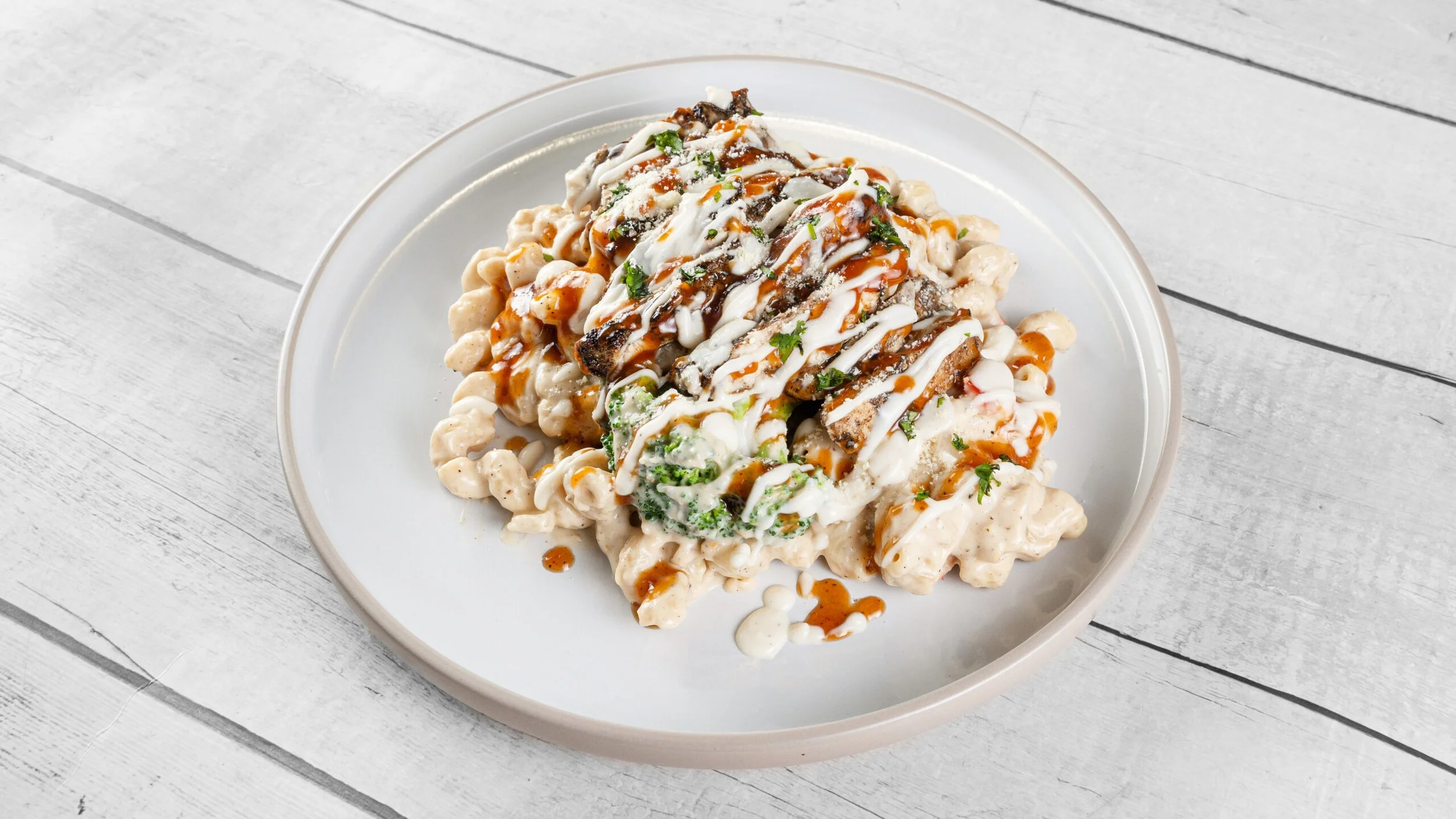Creamy jerk chicken Alfredo pasta with penne noodles, broccoli, parmesan, and bold Caribbean seasoning from Palate Bomb.
