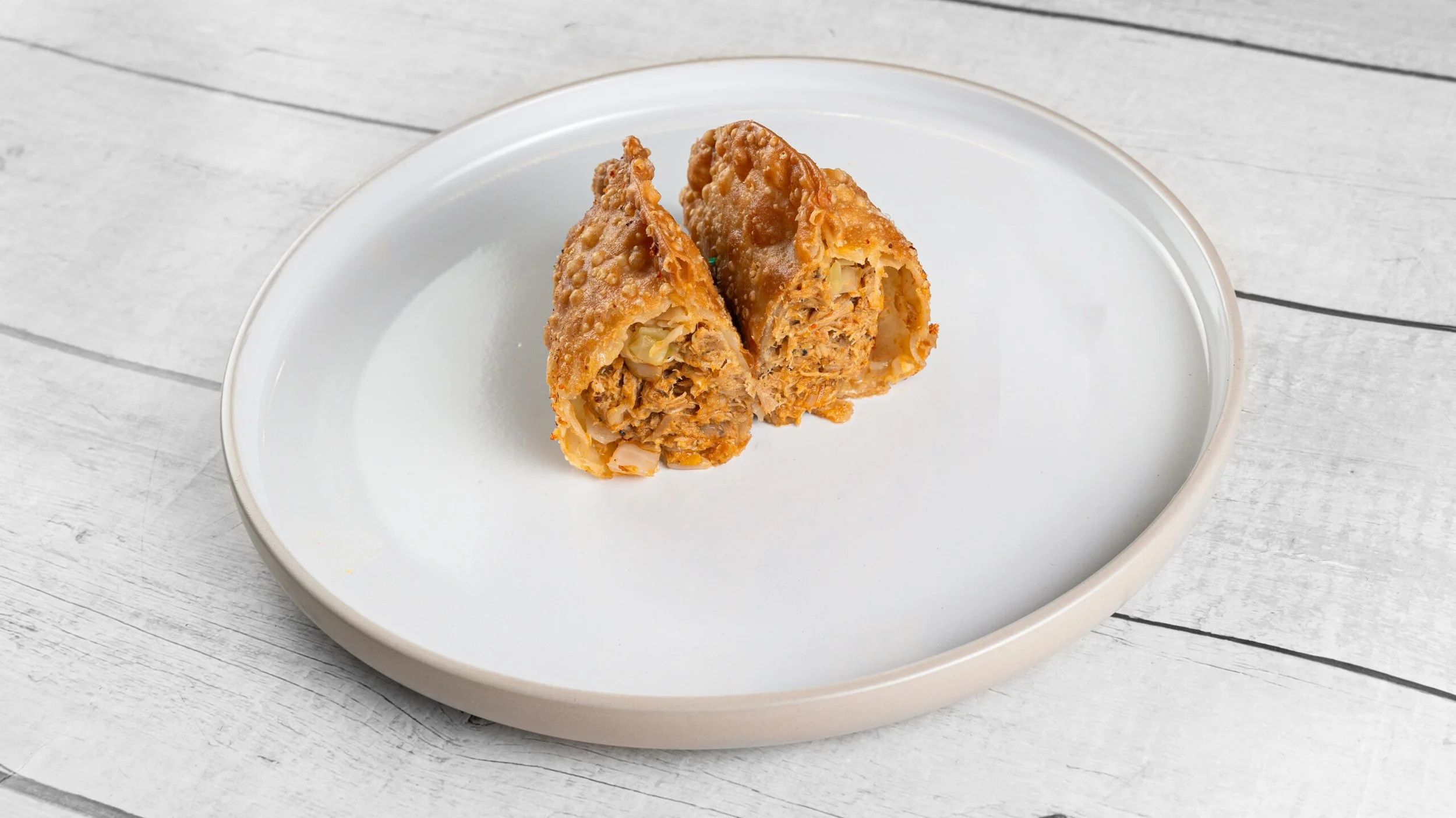 Crispy Haitian chicken patté stuffed with seasoned shredded chicken, cabbage, and bold island spices from Palate Bomb.