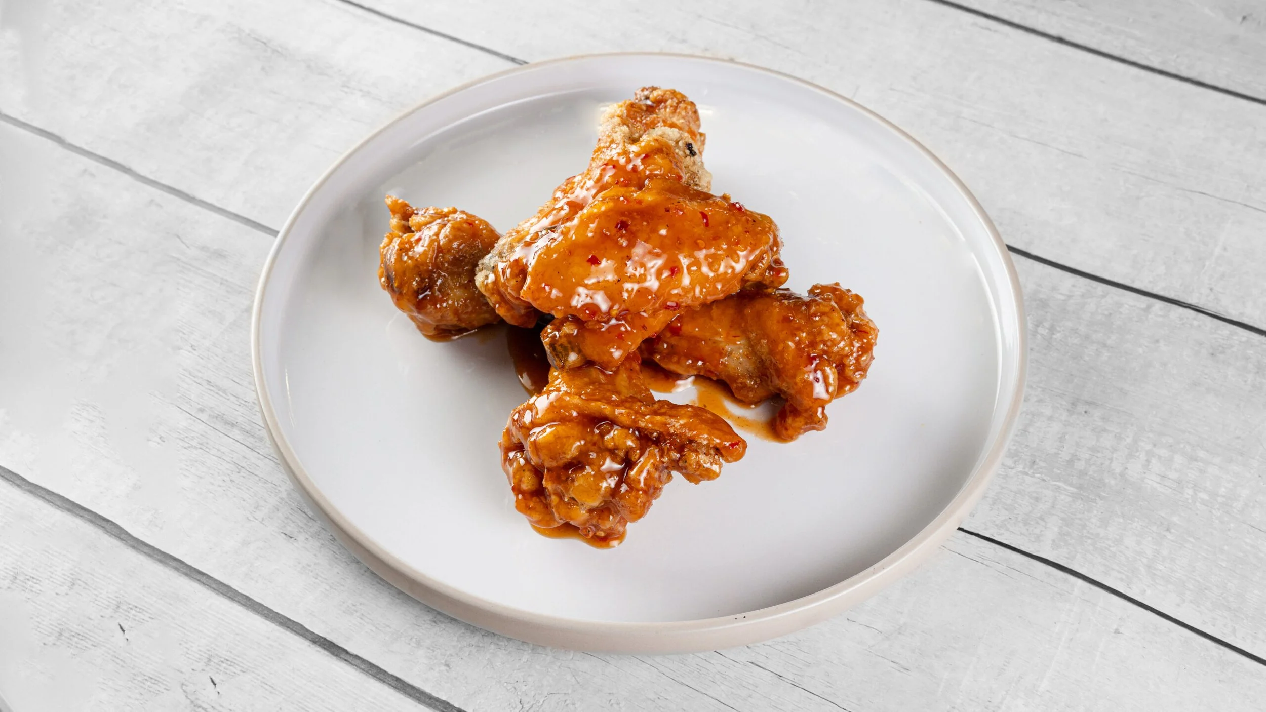 Crispy seasoned chicken wings with a crunchy golden coating served fresh from Palate Bomb late-night kitchen in Miami Gardens.