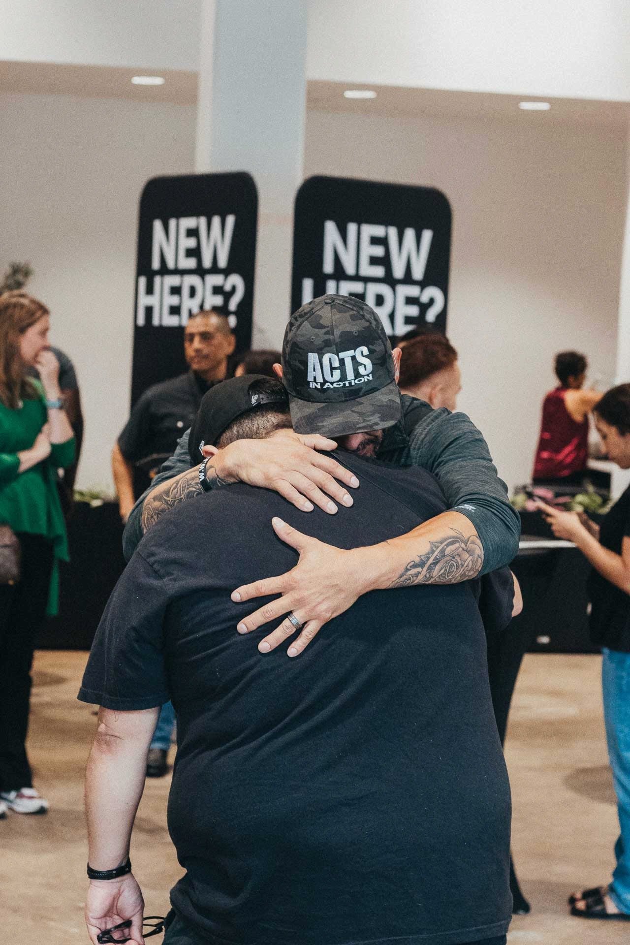 Welcome Team host greeting a first-time guest at the New Here tent at Pearl Street Church
