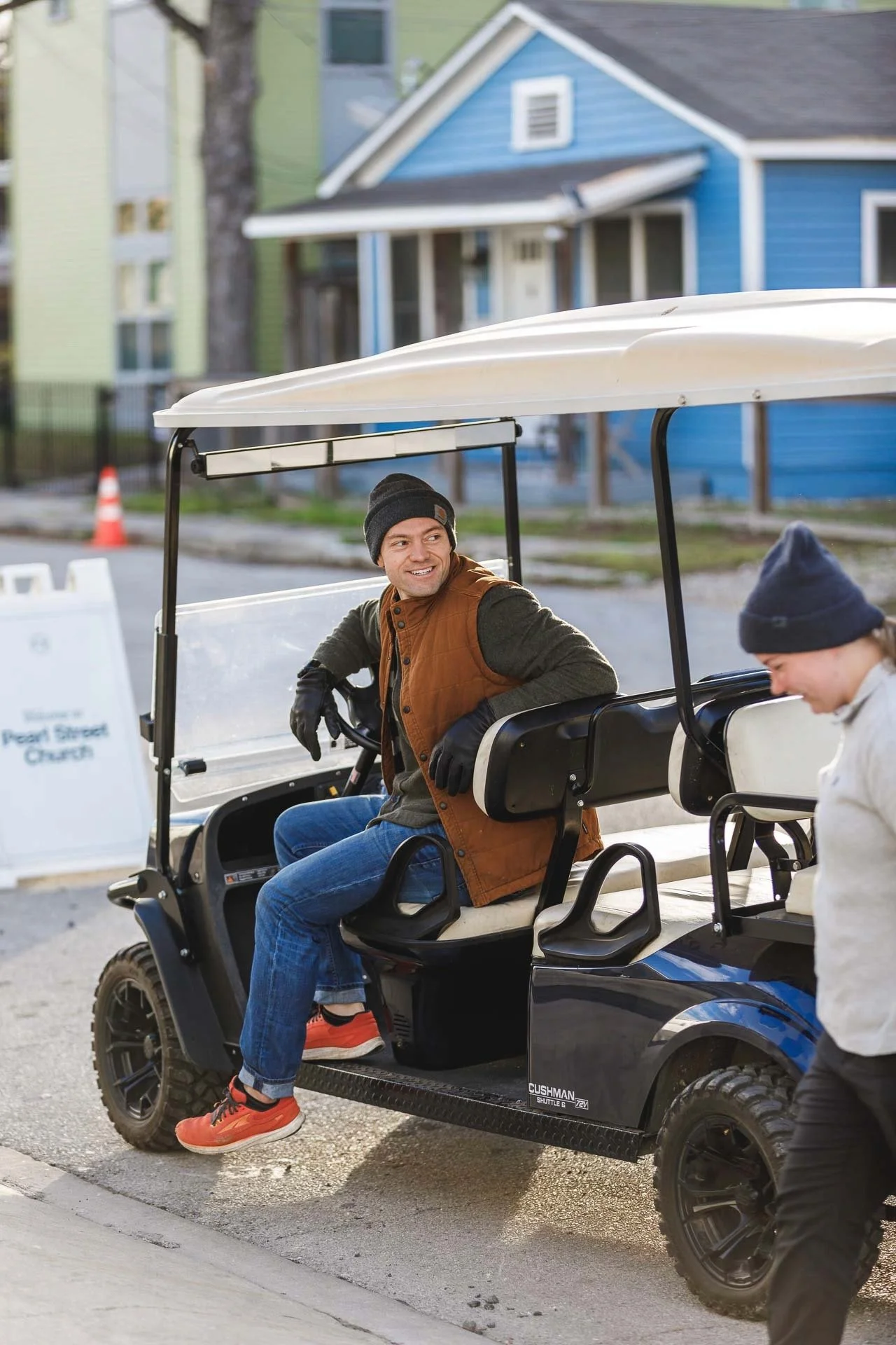 Parking team volunteers on a golf cart greeting guests at Pearl Street Church Downtown