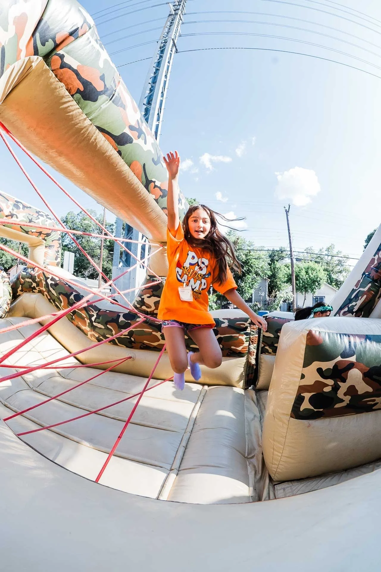 Kid on a bounce house at Pearl Street Church Kids Camp