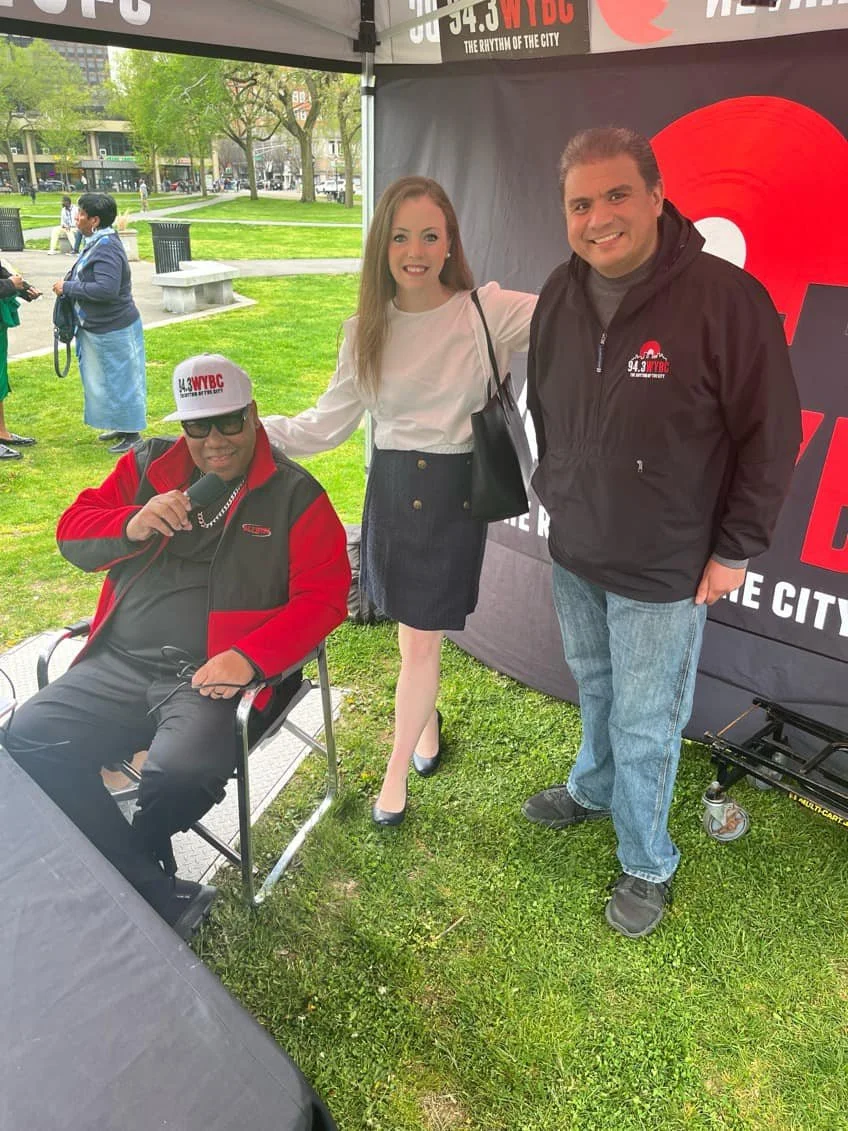 Elizabeth Protzman with DJs from WYBC 94.3 The Beat in Connecticut during a radio appearance focused on advocacy, community engagement, and public impact.