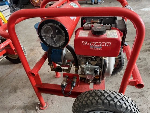 Red portable oil skimmer with a Yanmar diesel engine and large black wheels.