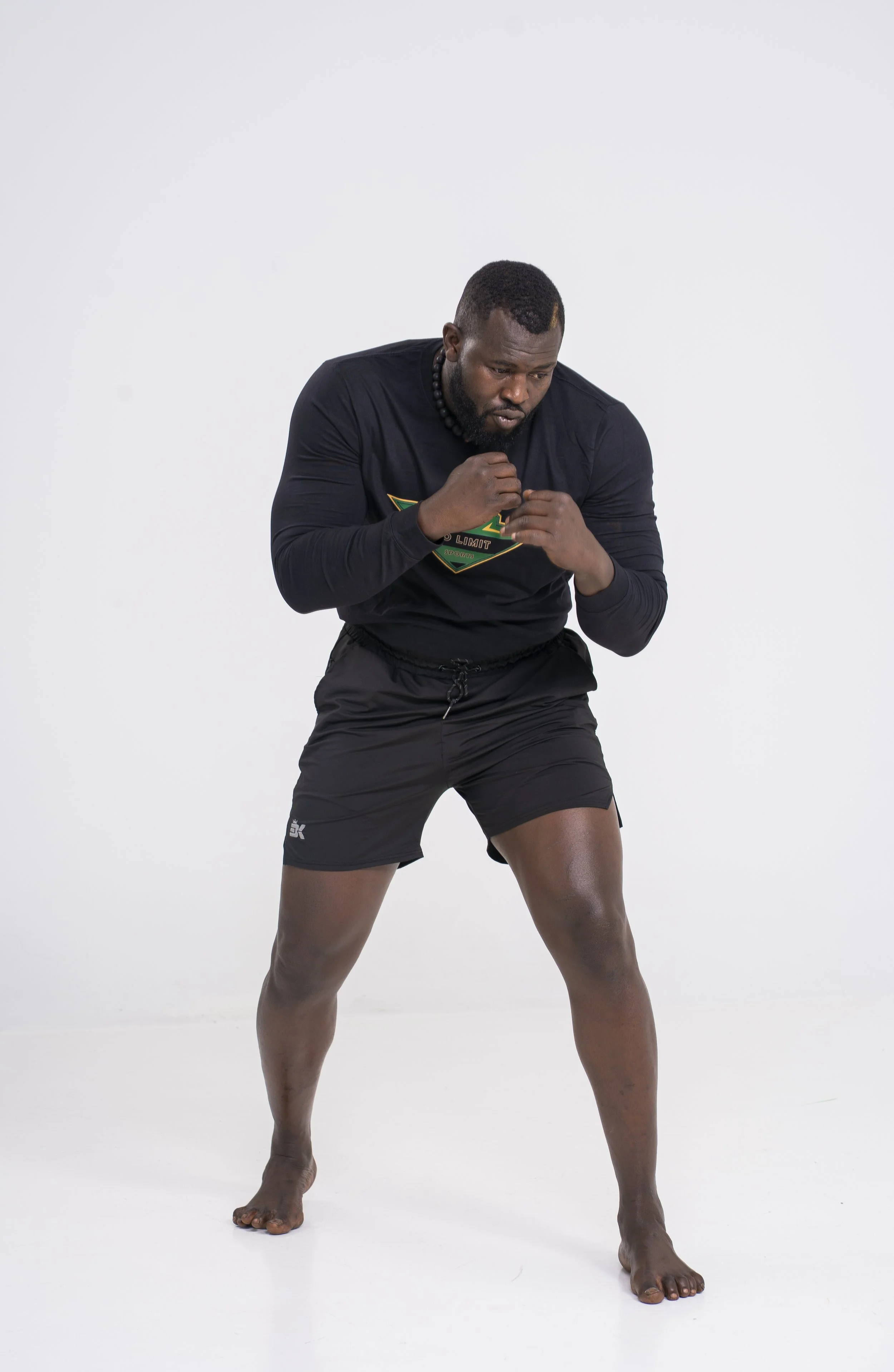Bakary posing in a boxer stance during a No Limit Sports photoshoot