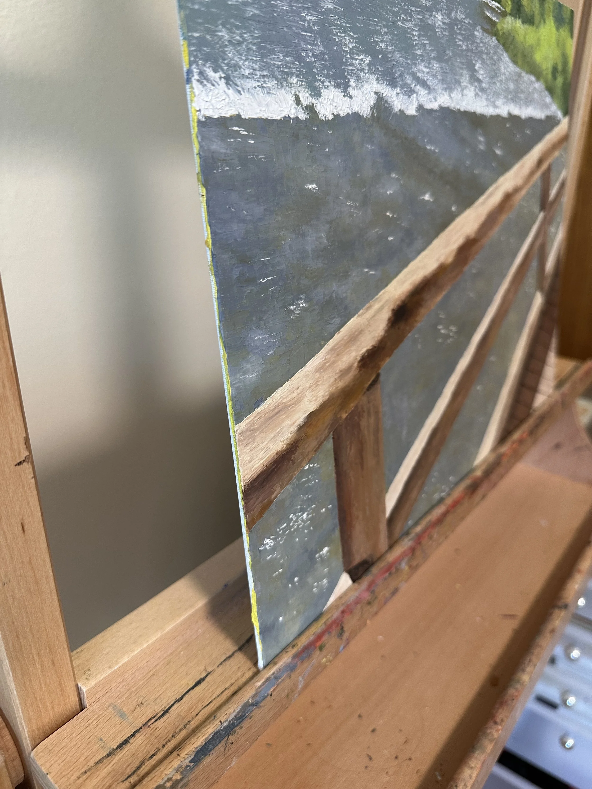 A photograph showing the side edge of an original palette knife oil painting of Jenny Lake at Grand Teton National Park.