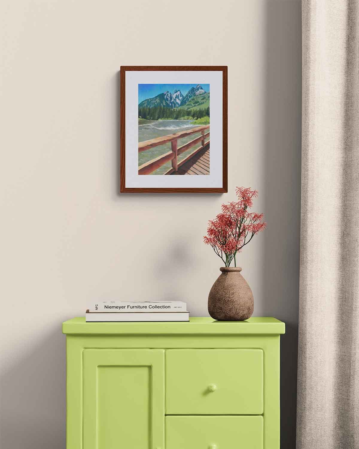A framed oil pastel painting of a bridge over Jenny Lake in Grand Teton National Park.