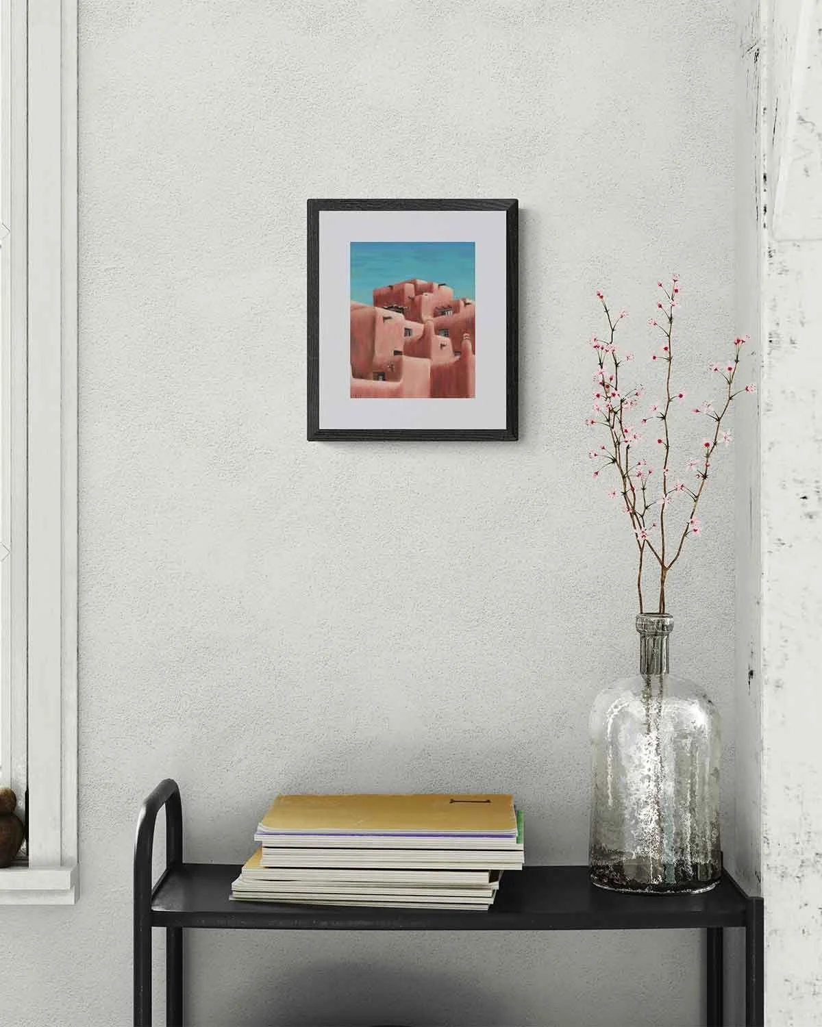 A framed oil pastel painting of the Inn And Spa at Loretto, an adobe building.