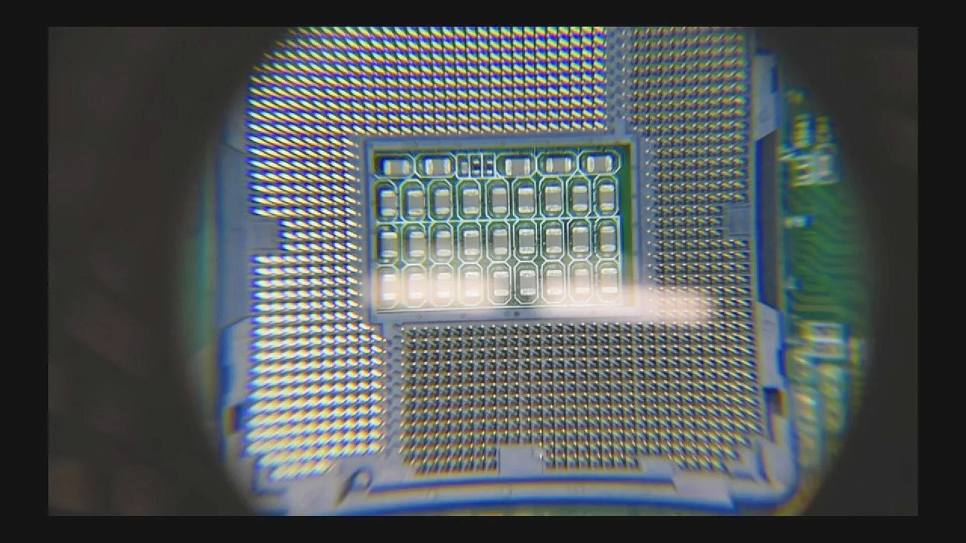 A computer CPU socket under a magnifier