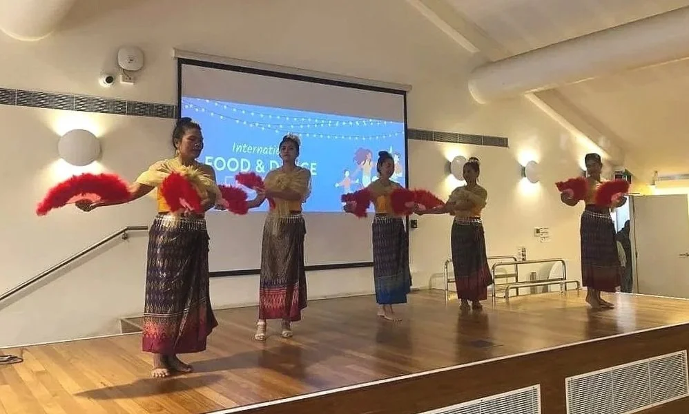 A group of performers dancing at the International Food and Dance Festival.