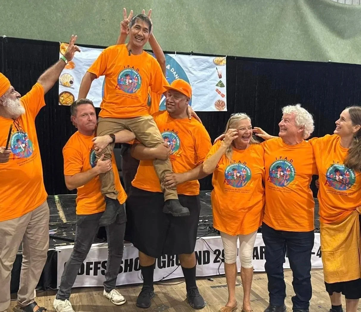 A group of volunteers celebrating the International Food and Dance Festival.