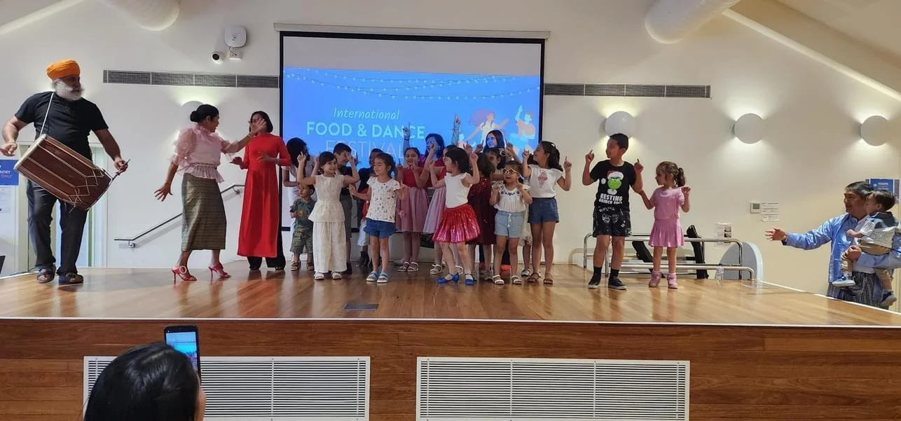 A group of performers dancing at the International Food and Dance Festival.
