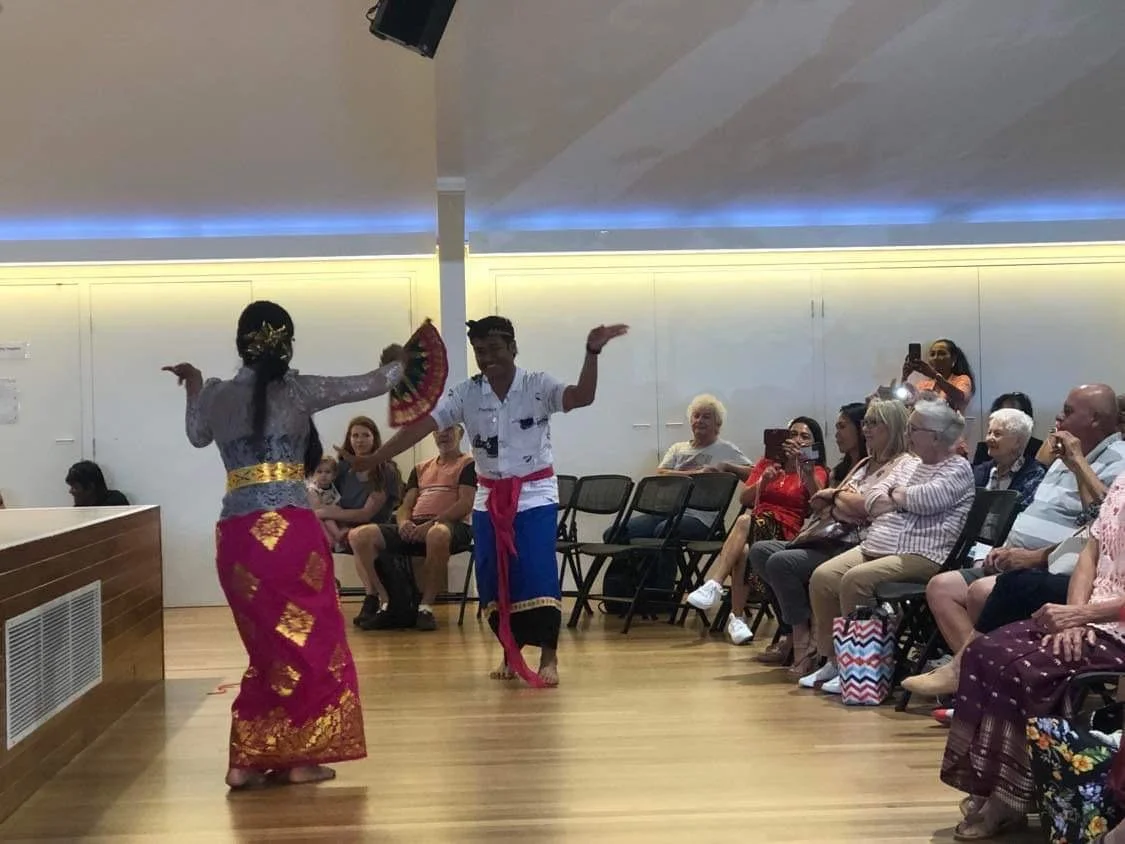 A group of performers dancing at the International Food and Dance Festival.