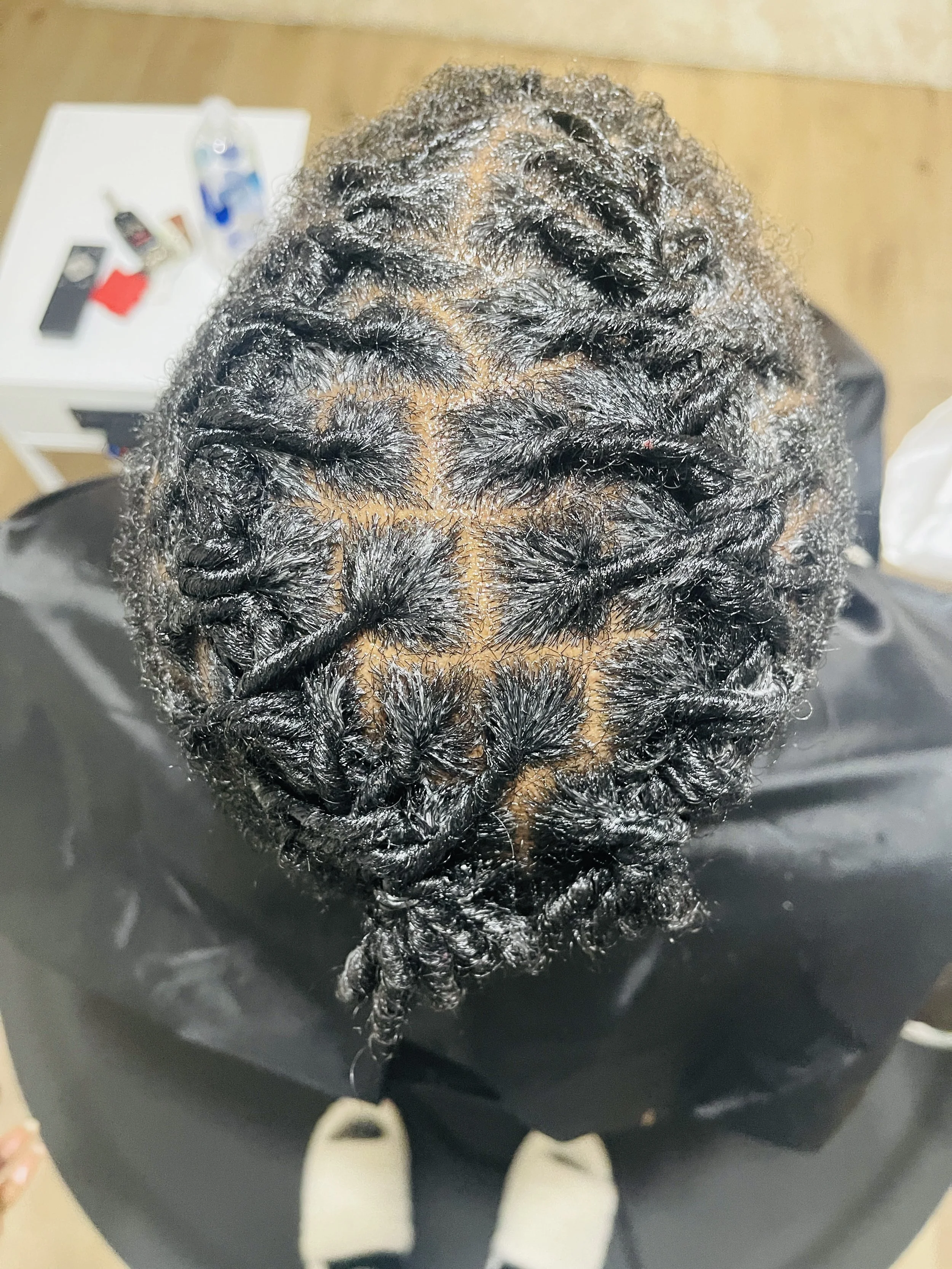Top view of a person's head with freshly washed, styled, and twisted natural curly hair.