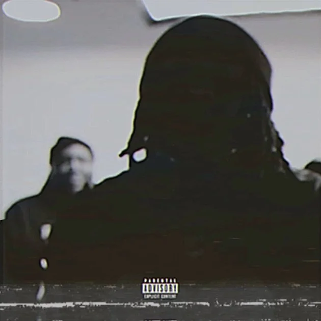 Silhouette of a person with long dreadlocks in a dark hoodie, facing away, with another person's face visible in the background.